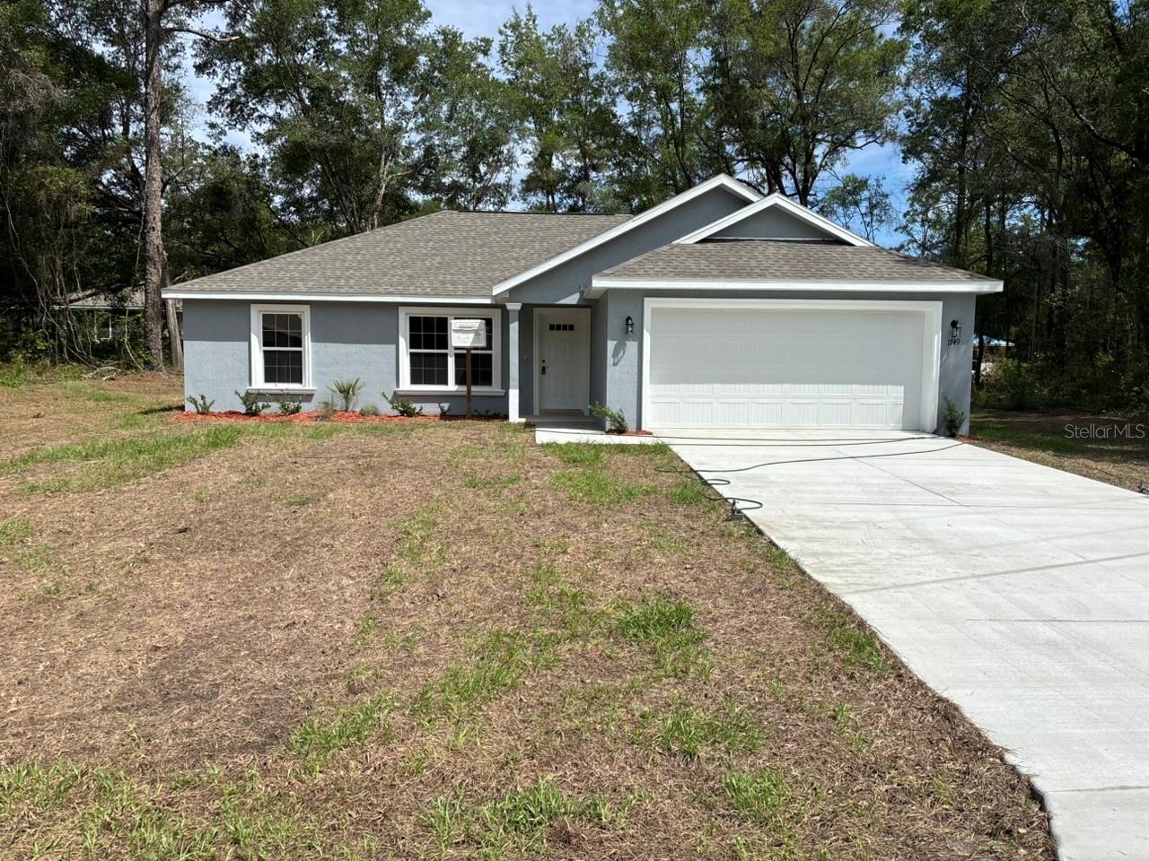 NEW CONSTRUCTION. MOVE-IN READY! Welcome to the Key West Model in Citrus Springs, a beautifully built 3-bedroom, 2-bathroom home with 1,405 square feet of comfortable living space. This home features concrete block construction, a 30-year architectural shingle roof, energy-efficient double-pane windows, and a 10-year structural warranty for lasting peace of mind. Inside, the main living area offers vaulted ceilings and luxury vinyl plank flooring throughout the home for a clean, modern feel. The kitchen includes stainless steel appliances, custom white shaker cabinets with soft-close drawers, granite countertops, and a pantry. The bathrooms also feature granite countertops and quality finishes. Enjoy outdoor living on the covered patio, plus the convenience of washer-and-dryer hookups and an attached 2-car garage with an opener and remotes. With no HOA fees for added ownership freedom and a flood zone X location that requires no flood insurance, this new home is ready for you to move in and enjoy.