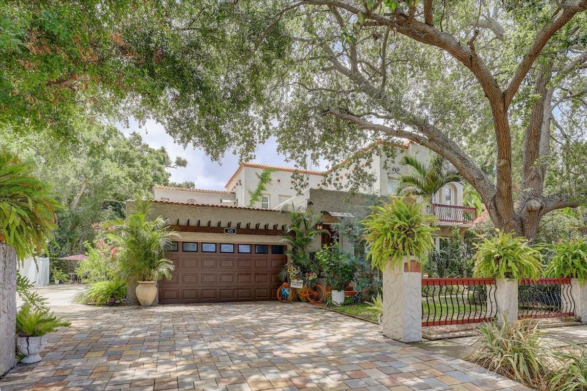 Legend has it, George Herman Ruth Jr. better known as Babe Ruth, the American Hall of Fame baseball player owned and used this home as a private get-way. Welcome to The Hacienda, a historic, Spanish-Mediterranean style home in St. Petersburg, Florida. Built in 1926 and resting on almost a quarter acre, this 5 bed, 5 bath stands like a fortress. Strongly constructed block walls, rustic heavy wood doors, private balconies, and red clay tile edged roof, all reflect the building elegance of the Roaring 20’s with grace and style. The grounds are lush and green with mature hibiscus and arcadia palms, featuring quiet areas for relaxation and connection. The old tree-swing out front, the fountain filled with flowers, the shady stone sidewalk and wide-open courtyard bring calm to the soul. The grand front door opens to a mosaic tile entrance which provides a warm welcome, the fully restored original hardwood floors draw you into their luster, signature stucco accent the exotic curves of the arched entryways, rounded custom windows lead the eye to the majestic fireplace. A stunning, open air private patio is situated in the center of the home and open to the stary sky at night. Filled with romance and visions of the past, this home pulls you into an era of leisure and legends. All 5-bedroom suites have their own designated kitchenette and full bathroom with luxurious original hardwood floors and historic touches. The first floor has an in-law suite with a full custom kitchen, granite countertops and lots of storage areas. The primary kitchen is complete with custom cabinets, stainless-steel appliances and granite countertops. Outback, the wide veranda sits surrounded by the grand arcade with the salty terracotta tiles, hardwood ceilings and the coolness invites you to stay for a cold glass of lemonade. Catch some sunshine in the large courtyard or enjoy the shade surrounded by foliage and privacy.
The property conveys fully furnished and is an active bed and breakfast rated in the top 10 percent in St Petersburg. It boasts 8 designated parking spots in addition to the 2 car garage. Just 4 miles from the beach, this rare piece of Florida brings historic value, memories and timeless beauty. A unique opportunity to own a place where the past still lives beautifully today. Welcome home!