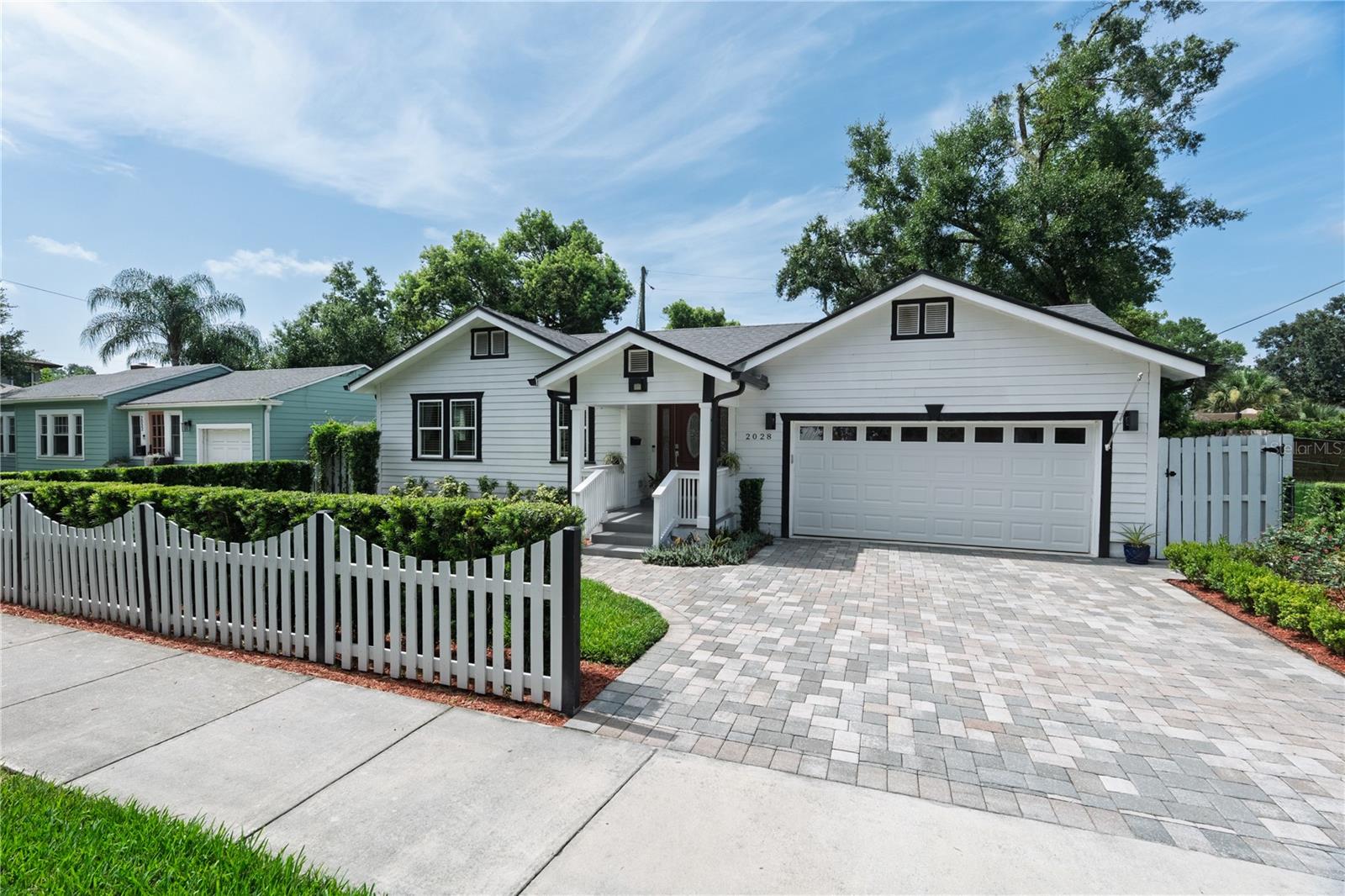 Have you always wanted a charming house with a white picket fence accompanied by beautiful landscaping? Welcome to this wonderful family home in one of Orlando’s most coveted neighborhoods. You’ll appreciate the nuances of a newer home built in 2020 yet blending seamlessly with the character of the surrounding neighbors.  This is a spacious open three-way floorplan with a second ensuite bedroom in addition to the primary.  Enter through the attractive front doorway into the large living room. French doors lead to two bedrooms with closet systems and a shared bath. Follow through to the dining room, which is large enough for a table for ten enroute to the junior suite with its own private bath and a walk-in closet.  The open kitchen has an 11ft breakfast bar in addition to a massive cooking island, wine refrigerator, plenty of marble counter space and great natural light. Finally, the fantastic oversized primary suite: a huge closet with built-ins, a spacious bath with dual sinks, a soaking tub and separate step-in rain shower.  Outside through the sliding doors in the kitchen is an attractive pergola with pavers, which can be covered by the attached sunshades. The yard is surrounded by privacy fencing and is large enough for a future pool if desired.  Other notable features include an indoor laundry room with cabinets, a pantry, new roof installed in 2024, crown moulding throughout, wainscotting in the kitchen and dining room, bamboo flooring throughout main living areas with tile in the kitchen and baths, granite bathroom counter tops, attractive pavered driveway, extra storage room in the rare 2 car garage, outfitted with Level 2 EV charging and a 50-gallon water heater.  This home is located just across the road from a neighborhood open lot where you can enjoy occasional get-togethers with your fellow Colonialtown North community; one where the neighbors also decorate the local round-about during the holidays and even have a tree lighting ceremony. Does this sound like a Hallmark movie? The neighborhood sidewalks are canopied by beautiful oak trees to enjoy your morning and evening strolls. Just minutes from Downtown, Mills 50, Milk District, Baldwin Park, Audubon Park K-8, and about 20-30 minutes to Orlando International Airport and the theme parks. Come make it your own before someone else does! More pictures to follow soon.