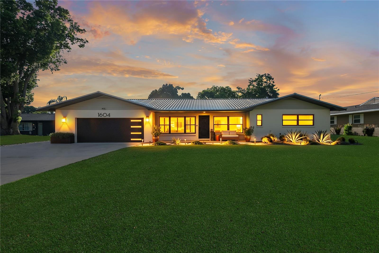 Under contract-accepting backup offers. Chain-of-Lakes Waterfront Living at Its Finest! Welcome to this beautifully renovated 3 bedroom, 3 bath (2 BR/2BA in main house and 1 BR/1BA in Guest Suite) canal front home offering direct access to Lake Eustis and the renowned Harris Chain of Lakes. Whether you're an avid boater, fisherman, or simply love waterfront living, this property delivers the Florida lifestyle you've been dreaming of.
Thoughtfully updated with top of the line finishes, this home features a fully remodeled kitchen with shaker cabinetry, quartz countertops, a large center island, stainless steel appliances, double ovens, beverage refrigerator, Bosch dishwasher, and a full height designer backsplash. Original terrazzo floors have been professionally restored, while updated lighting, solid wood shaker doors, plantation shutters, and beautifully renovated bathrooms provide modern comfort throughout. Step outside to your own private backyard oasis featuring a screened Florida room, custom entertaining space, 24' x 12' pool, and nicely constructed 10' x 20' climate-controlled guest suite complete with a split-system A/C, tankless water heater, and walk in shower. Boating enthusiasts will appreciate the 80 feet of canal frontage, covered boathouse with boat lift, metal seawall, updated lift motor, dedicated electrical service, and quick access to Lake Eustis, Lake Dora, the Dora Canal, Haynes Creek, and the St. Johns River. Major improvements provide peace of mind, including a 2018 metal roof, 2023 HVAC system, 2021 PEX plumbing, 80-gallon water heater with hot water recirculation, and 2024 exterior stucco and paint. The oversized two-car garage offers abundant storage, attic space, workbench, utility sink, and a new insulated garage door. Street legal Golf cart access to downtown Tavares and Mt Dora, waterfront restaurants, shopping, and year-round events, this exceptional property combines luxury, recreation, and convenience in one incredible waterfront package. Don't miss this rare opportunity to own a move-in-ready home with direct access to Central Florida's premier chain-of-lakes. Schedule your private showing today!