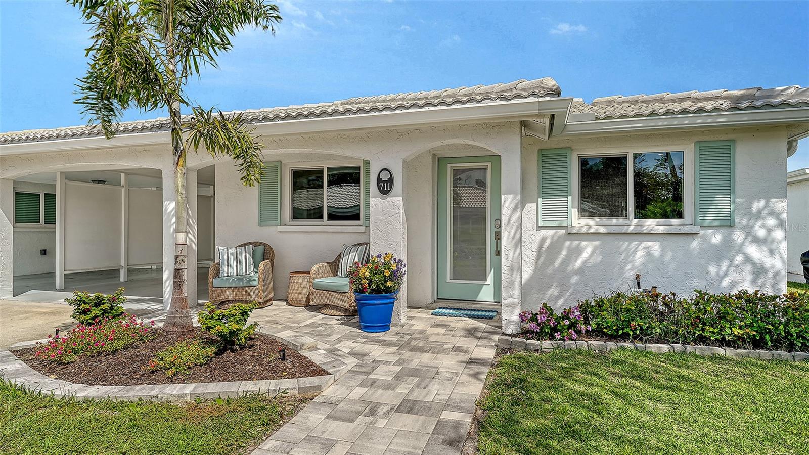 Calling all boaters. If you have ever considered living on Longboat Key in sunny beautiful Florida, now is your chance! This amazing villa is available and ready for you to move to paradise! 711 Spanish Dr. S. is a 2 bedroom/2bath home that has been newly renovated in 2025/2026 and it is beautiful! Entering the home your eyes are immediately drawn upwards to the gorgeous open beam 10’-12’ ceiling over the kitchen and dining area. The kitchen is complete with all new wood cabinets, new stainless top of the line appliances, undermount sink, Quartz counter tops, and an oversized island with a dark blue base which brings in a beautiful pop of color. The open floor plan flows easily with luxury vinyl connecting all the rooms. The dining living combination is airy and bright. The primary bedroom is divided from the Florida room with textured glass pane sliding doors that allow the light in but keep the space quiet and private. Beautifully renovated primary bath is tastefully appointed. The guest bedroom and bath have been updated with the same quality and fine design as the entire villa. The large Florida room houses the stacked washer and dryer in their own space. A stylish glass back door leads to the brick patio perfect for your potted plants and just sitting and enjoying the perfect Florida weather. A newly installed PVC gate secures the common area shared by the adjoining villa. Perfect area for grilling, storage of bikes, beach chairs, paddle boards and more. There is also easy access to the unit's storage room. The adjoining sister villa 703 Spanish Drive South is also for sale. If purchased together, new owners could have two homes available for friends

and family gatherings, with multigenerational potential. Imagine 2 fabulous full kitchens, 4 bedrooms, 4 baths and lots more space for sleeping. This is a must see! Make it your new home with all hurricane rated windows and doors, and so much more. This vibrant 55+ community of Spanish Main Yacht Club neighborhood is full of wonderful neighbors, and lots of amenities, shuffleboards, swimming pool, private deeded beach access to the gorgeous Longboat Key beaches and the warm Gulf waters. Fishing, boating and so much more. The expansive 40 slip Marina in the envy of all boaters as the lease is extremely inexpensive to lease, you won’t believe it. Call for details. Close to St Armands Circle and downtown Sarasota makes this location perfect for shopping, dining, theater, botanical gardens, airport and more. All 212 units in Spanish Main Yacht Club are under FEMA regulations, guidelines and stringent adherence to rebuild specifications. All FEMA regulations completed including inspections. Come and enjoy your soft place to land in this world.