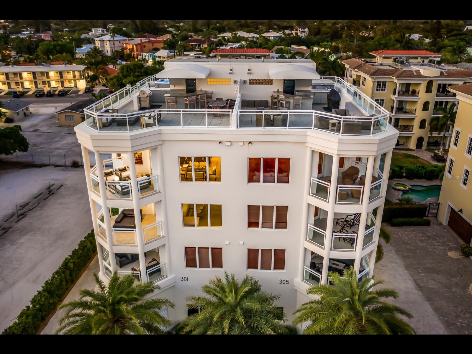 Experience the ultimate in beachfront luxury living with this exquisite Penthouse Villa, located just steps away from the pristine Siesta Key beach. This stunning property offers panoramic views of the Gulf, and a 2-minute walk into the vibrant dining and shopping district of Siesta Village.

Nestled in a boutique luxury building of only 4 total units, this hybrid living offers the best of both worlds - the privacy of your own home with the benefits of a lock-and-leave condo. Indulge in the Florida lifestyle and watch the sunset over azure Gulf waters from your own private rooftop terrace. Unwind in the hot tub, kick back by the fire pit and entertain behind a full bar and kitchen.

The interior is equally impressive, with multi-level living featuring two guest quarters, a formal living room with wet bar and private terrace. An epic master suite is serviced by a private elevator to each level, elevating living to the next level. After soaking up the sun on the sand, cool off in the pool before gathering in the chef’s kitchen or on an additional terrace adjacent to it with family or guests before hitting the Village for the evening.

This rare gem on Siesta Key is truly an opportunity to experience the youthful and vibrant lifestyle of the area from a bird’s eye view. With virtual and in-person showings available, don't miss your chance to live the good life in this exceptional Penthouse Villa.