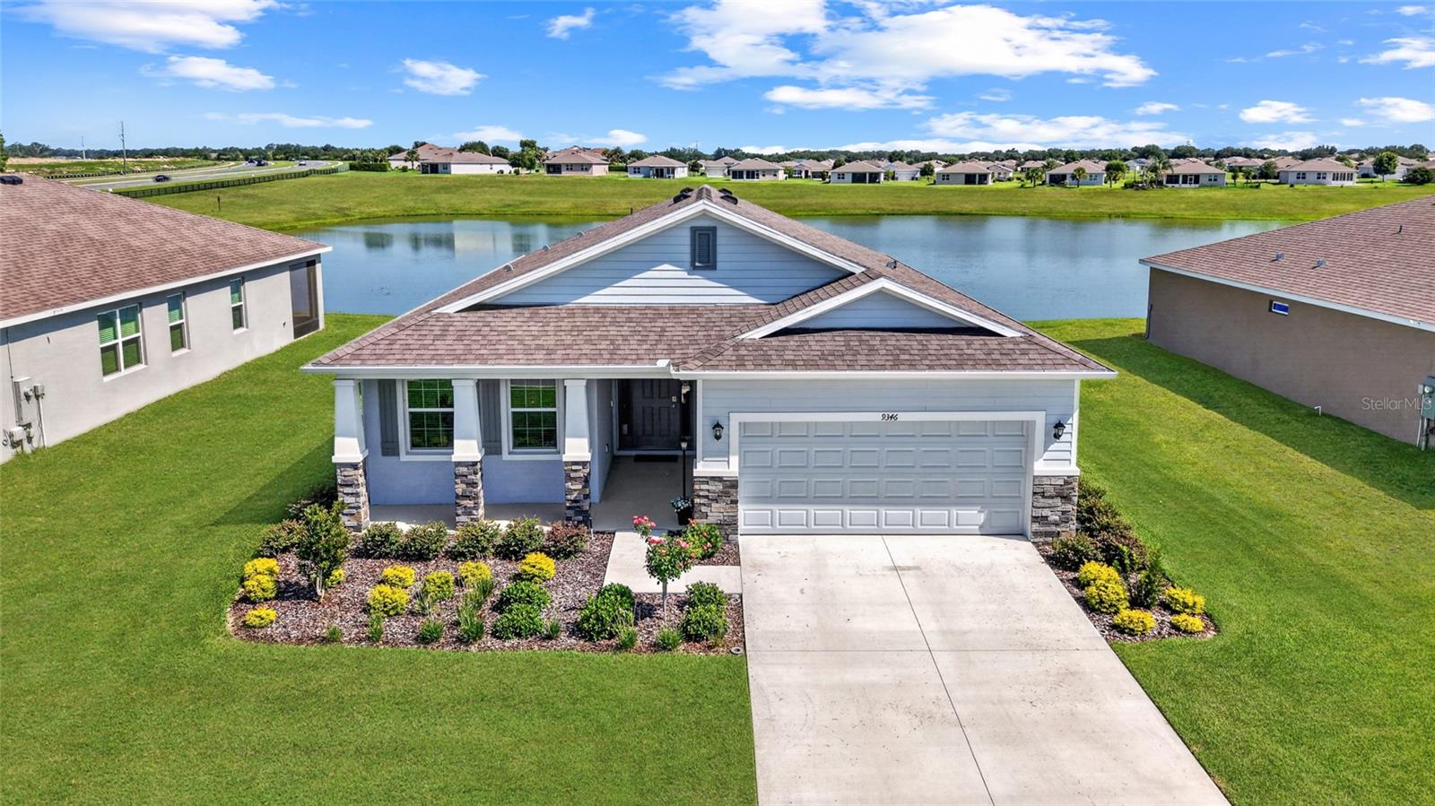 This beautiful Laurel model built in 2025 embraces the ease of retirement living with priceless, tranquil water views in JB Ranch, a gated 55+ community offering gracious amenities and included lawn care for low-maintenance living. Bright, airy interiors create a peaceful backdrop for everyday comfort, with an open layout that draws your eye toward the serene water just beyond the windows. The spacious gathering room features low-maintenance tile flooring and glass sliders that open to a screened-in lanai offering an ideal spot for morning coffee, afternoon reading, or effortless outdoor entertaining while overlooking the shimmering water. The well-appointed chef’s kitchen makes meal preparation simple and enjoyable, offering a casual breakfast nook, stainless-steel appliances, staggered-height cabinetry, a generous island with bar-height seating, recessed LED lighting, granite countertops, and a pantry for added storage. The owner’s suite is a restful retreat with a tray ceiling, plush carpeting, a spacious walk-in closet, and calming water views. Its spa-inspired ensuite bath includes a tile-lined walk-in shower with grab bars, a separate soaking tub, a double-sink vanity, and a private water closet for comfort and convenience. Conveniently positioned along the SR 200 corridor near shopping, banks, restaurants, and top medical facilities, this inviting residence offers a relaxed, low-maintenance retirement lifestyle enhanced by priceless water views. Residents of JB Ranch also enjoy access to a thoughtfully designed clubhouse where neighbors can gather for community meetings, host catered events using the on-site kitchen or stay active in the fitness center. Outside, an inviting pool and patio area create the perfect setting for sunny Florida afternoons, while bocce ball and pickleball courts offer fun ways to stay social and engaged. Together, the serene water views, convenient location, and well-planned amenities make this home an exceptional choice for comfortable and enjoyable retirement living. This home also features a fenced-in yard, ceiling fans, outdoor security lighting, an accessibility ramp in the garage, and grab bars installed in both bathrooms for added convenience.  As a bonus for potential turnkey living, the owner is also offering many of the home’s beautiful furnishings at greatly reduced prices!
