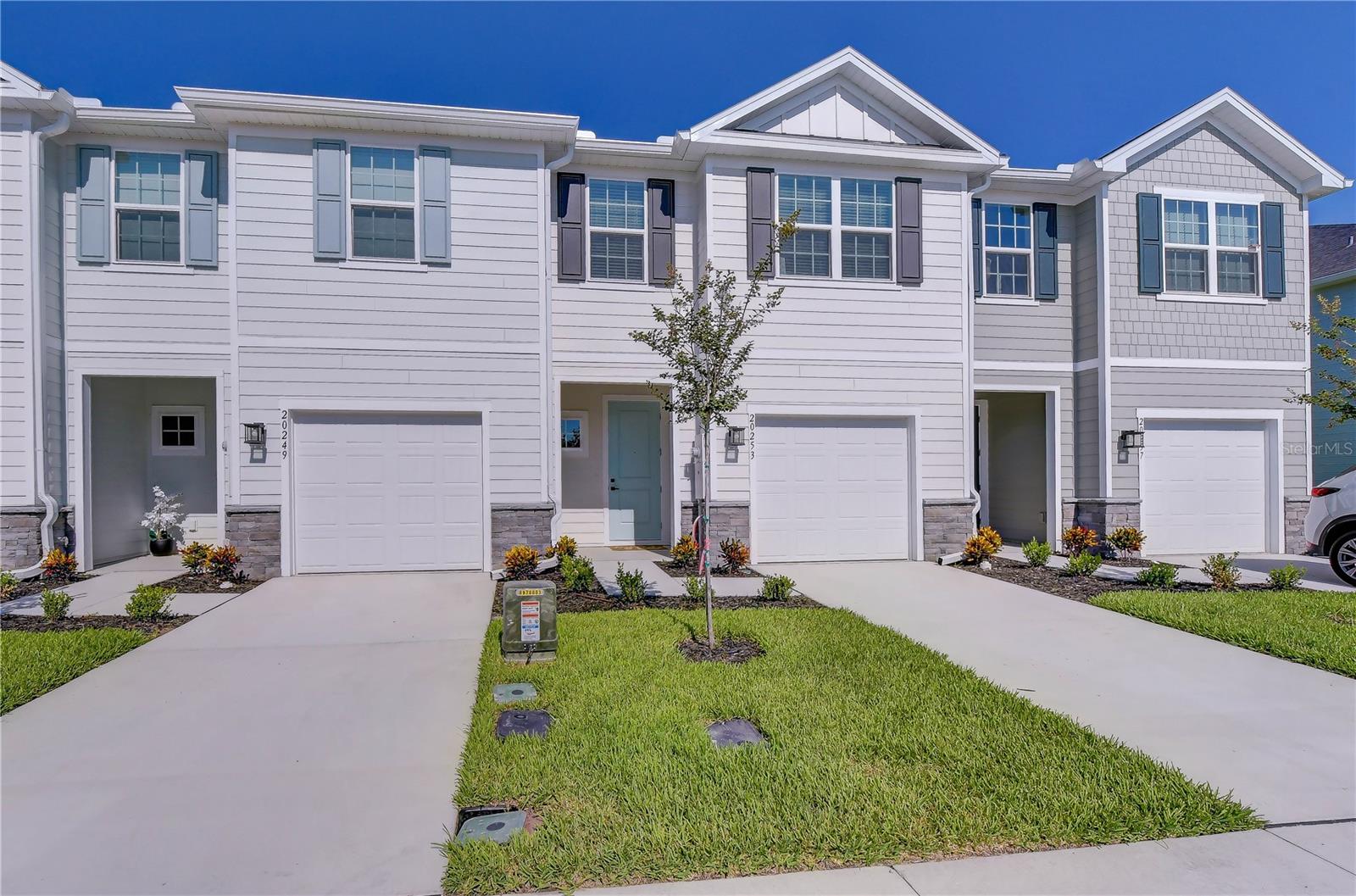 Be the first to enjoy this never-lived-in, newly completed 2026 townhome in Timbergrove, one of Lutz's newest communities! Built by Ryan Homes, the popular Mayport floor plan offers 1,674 square feet of thoughtfully designed living space with 3 bedrooms and 2.5 bathrooms. This exceptional middle-unit home has been appointed with the builder's top-tier premium upgrade package, showcasing many of Ryan Homes' highest-end design selections, upgraded finishes, and enhanced features throughout. The welcoming foyer leads into the spacious living area, offering convenient access to the attached 1-car garage, a stylish half bath, and the heart of the home's open-concept floor plan. The beautifully appointed kitchen features a large center island, stainless steel appliances, ample cabinet space, and overlooks the living and dining areas, making it ideal for everyday living and entertaining. Extend your living space outdoors with an open back patio and a partially fenced backyard. Retreat upstairs to the luxurious owner's suite, complete with two large walk-in closets and a spa-inspired en suite bathroom featuring dual vanities and a modern tiled walk-in shower. Two additional bedrooms, each with ceiling fans and generous closet space, are located down the hall alongside a full bathroom, offering the perfect layout for guests, family, or a home office. An upstairs laundry room adds everyday convenience. Enjoy the benefits of ENERGY-EFFICIENT new construction, stylish finishes, and INCLUDED LANDSCAPING for effortless, low-maintenance living! Conveniently located with easy access to SR 54, N. Dale Mabry Highway, and the Suncoast Parkway, providing a quick commute to Tampa Premium Outlets, Tampa International Airport, Downtown Tampa, as well as a variety of shopping, dining, and entertainment. Don't miss your opportunity to lease this never-occupied townhome. Schedule your private showing today!