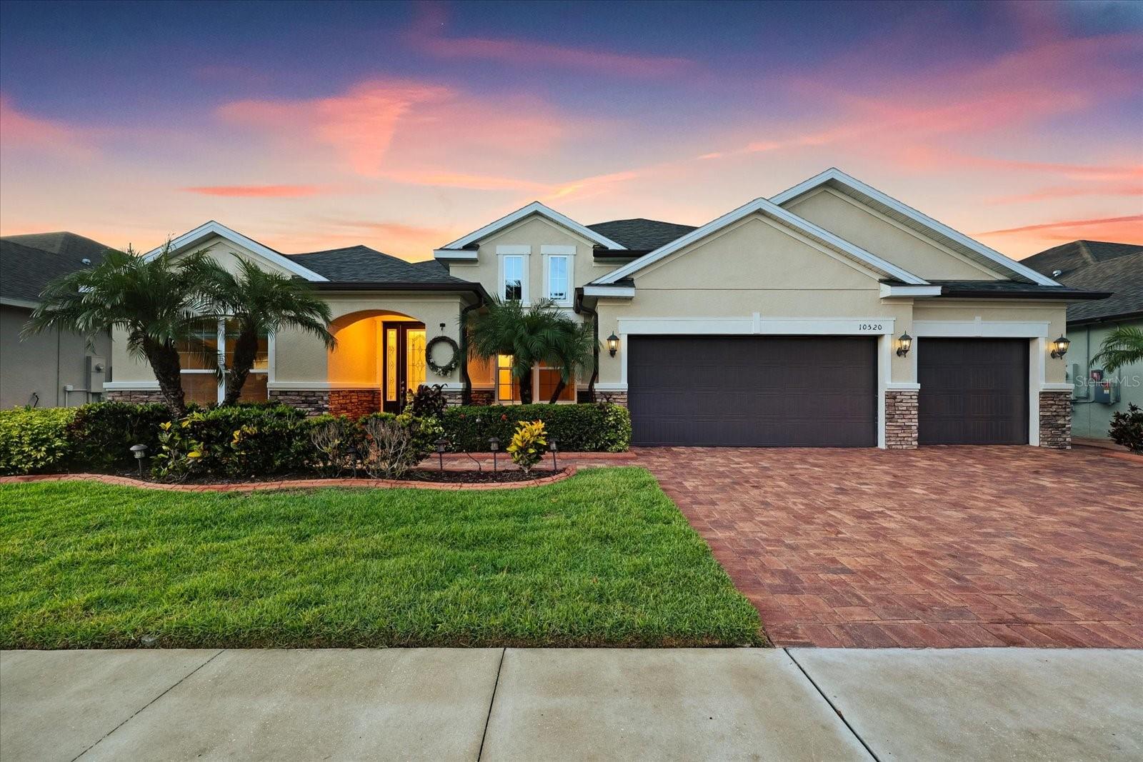 Welcome Home to this stunning Palermo model by Meritage Homes, perfectly situated on a premium pond-front lot in the gated community of Mariposa. Offering breathtaking panoramic water views and spectacular sunsets, this like-new 4-bedroom, 3-bath home with a private office combines luxury, functionality, and energy-efficient living with premium builder upgrades throughout. Enjoy peaceful waterfront living with serene pond views showcased through expansive pocket sliding glass doors in the main living area, seamlessly blending indoor and outdoor living while creating the perfect backdrop for everyday relaxation.
Exceptional curb appeal welcomes you with a 3-car garage, newly sealed brick-paver driveway and walkway, stone accents, fresh exterior and interior paint, gutters, tropical landscaping, and a fully fenced backyard offering both beauty and privacy. A NEW ROOF and new ceiling fans throughout add even more value, comfort, and peace of mind.
Inside, the open-concept layout is designed for both entertaining and everyday living. The chef-inspired gourmet kitchen showcases Quartz countertops, 42” upgraded cabinetry, stylish backsplash, stainless steel appliances, upgraded tile flooring, a spacious center island with pendant lighting, and an oversized walk-in pantry. Just opposite the pantry, a prep station/butler’s pantry provides additional cabinetry and countertop space perfect for a coffee or cocktail bar.
The home offers both formal and casual dining areas, along with a spacious family room filled with natural light. Custom shelving in the living and dining area adds character and functionality, while expansive pocket sliding glass doors seamlessly blend indoor and outdoor living, opening to breathtaking views of the pool, lanai, and tranquil pond.
The luxurious primary suite serves as a private retreat featuring glass sliders overlooking the water, dual vanities, a separate soaking tub, walk-in shower, and an oversized walk-in closet. A front guest bedroom with its own full bath is ideal for visitors or multigenerational living, while the additional bedrooms provide comfort and privacy for family and guests. Every bedroom features its own walk-in closet, offering exceptional storage and convenience throughout the home.
Step outside to your resort-style outdoor oasis featuring an extended covered lanai with travertine tile, oversized screened enclosure, and a sparkling saltwater pool with a self-cleaning system and peaceful waterfall feature. Whether enjoying your morning coffee or entertaining at sunset, the serene pond views and abundant wildlife create the perfect backdrop for Florida living.
Residents of Mariposa enjoy resort-style amenities including a community pool, clubhouse, built-in BBQ stations and playground. Conveniently located near the Selmon Expressway and Interstate 75, this home offers easy access to Downtown Tampa, shopping, dining, and Gulf Coast beaches while maintaining the tranquility of suburban living.
Built with Meritage Homes energy-efficient features for lower utility costs and enhanced comfort, this isn’t just a home — it’s a lifestyle.
