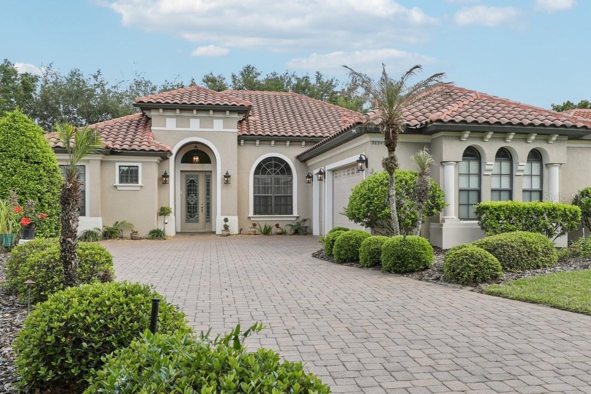 Discover timeless elegance and resort-style living at 26345 San Gabriel, nestled in the Las Colinas neighborhood within the Mission Resort & Club in scenic Lake County, Florida. Surrounded by 2 Championship Golf Courses, lush gardens, northern views, and enchanting wildlife, this meticulously maintained home offers the perfect blend of luxury, comfort, relaxation and privacy. 
Boasting 2,149 sq ft of thoughtfully designed living space, this residence features 3 bedrooms, 2 baths with classic ceramic tile flooring throughout and newer luxury viny in the bedrooms.
The formal living room is a showstopper with its massive 12 ft high triple tray ceilings and Tiffany style lighting. Recessed lighting sets the mood for entertaining or just relaxing. Enjoy memorable gatherings in the formal dining room with plenty of space for those formal entertainment nights with family and friends. Then relax in style with upgraded systems that include a Brand new HVAC 2024. 
The kitchen is a Chefs dream come true, complete with matching GE appliances, elegant cabinetry, gas stove and stylish canopy range hood that accents this beautiful kitchen. To finish off this home, an oversized, under-air, 600+ sq. ft. garage—perfect for the car enthusiast or a workshop, storage, and have room for your approved Mission Resort golf cart.! Life at Mission Resort & Club Located amidst the rolling hills and glistening lakes of Central Florida, Mission Resort & Club offers a rare lifestyle filled with recreation, relaxation, and refined charm. The community features: • Two championship golf courses • Four pickleball courts • All-weather tennis and beach tennis facilities • Hydro spa and full-service fitness center • Hotel with pool, hot tub, and three on-site restaurants Centrally located, you’re just minutes from theme parks, boutique shopping, local wineries, and more—offering both tranquility and accessibility. Golf or Social Membership is required, granting residents full access to the resort’s premier amenities and enhancing the luxury living experience.
