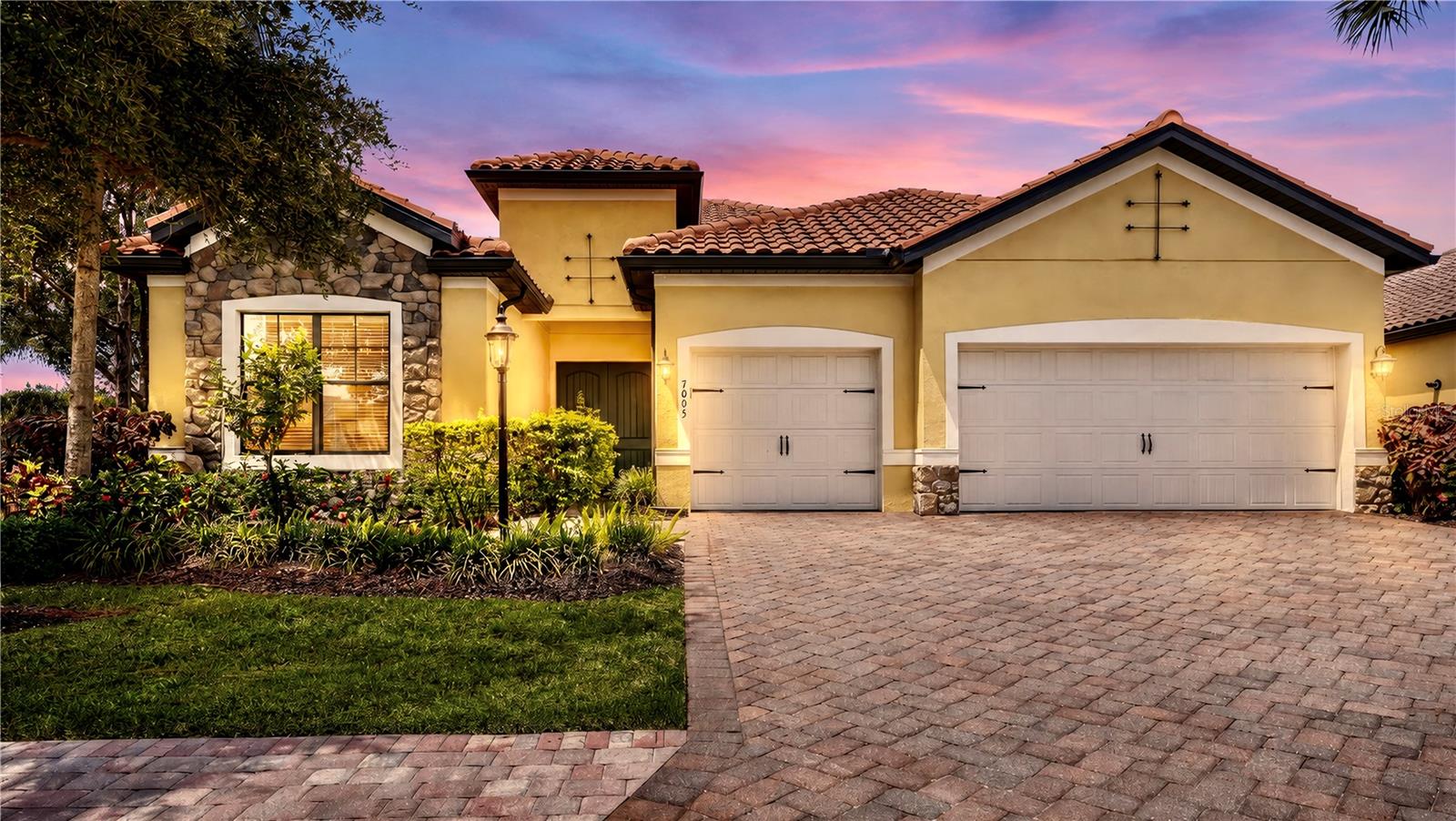 This former model home showcases exceptional craftsmanship, designer finishes, and an ideal maintenance-free lifestyle in the gated community of Country Club East. Perfectly positioned on a private, southwest-facing lakefront homesite with no home on one side, this light and bright residence features hurricane-impact glass and a whole-house generator for added peace of mind. The 2,427-square-foot floor plan offers 3 bedrooms, 3 bathrooms, a private office with double glass doors, and seamless indoor-outdoor living. Coffered ceilings, custom woodwork, built-ins, wall features, and custom closet cabinetry throughout showcase the home's outstanding quality and stylish design. The great room design offers an open kitchen, featuring a large center island, walk-in pantry, quartz counters, stainless-steel appliance and effortless connection to the living and dining areas. The primary suite opens to the lanai through sliding glass doors and includes a spacious en suite with double vanities, walk-in shower, soaking tub, and private water closet. Outdoors, enjoy a private pool and spa, outdoor kitchen, and peaceful lake views. Residents of Whittlebury enjoy maintenance-free living and access to The Retreat Aquatic & Fitness Center, while membership to the Lakewood Ranch Golf & Country Club is available but optional. Lakewood Ranch is the number one best-selling, multigenerational community in the country and located near world-class shopping, dining, entertainment and is minutes to I-75, beaches, great schools and medical facilities.