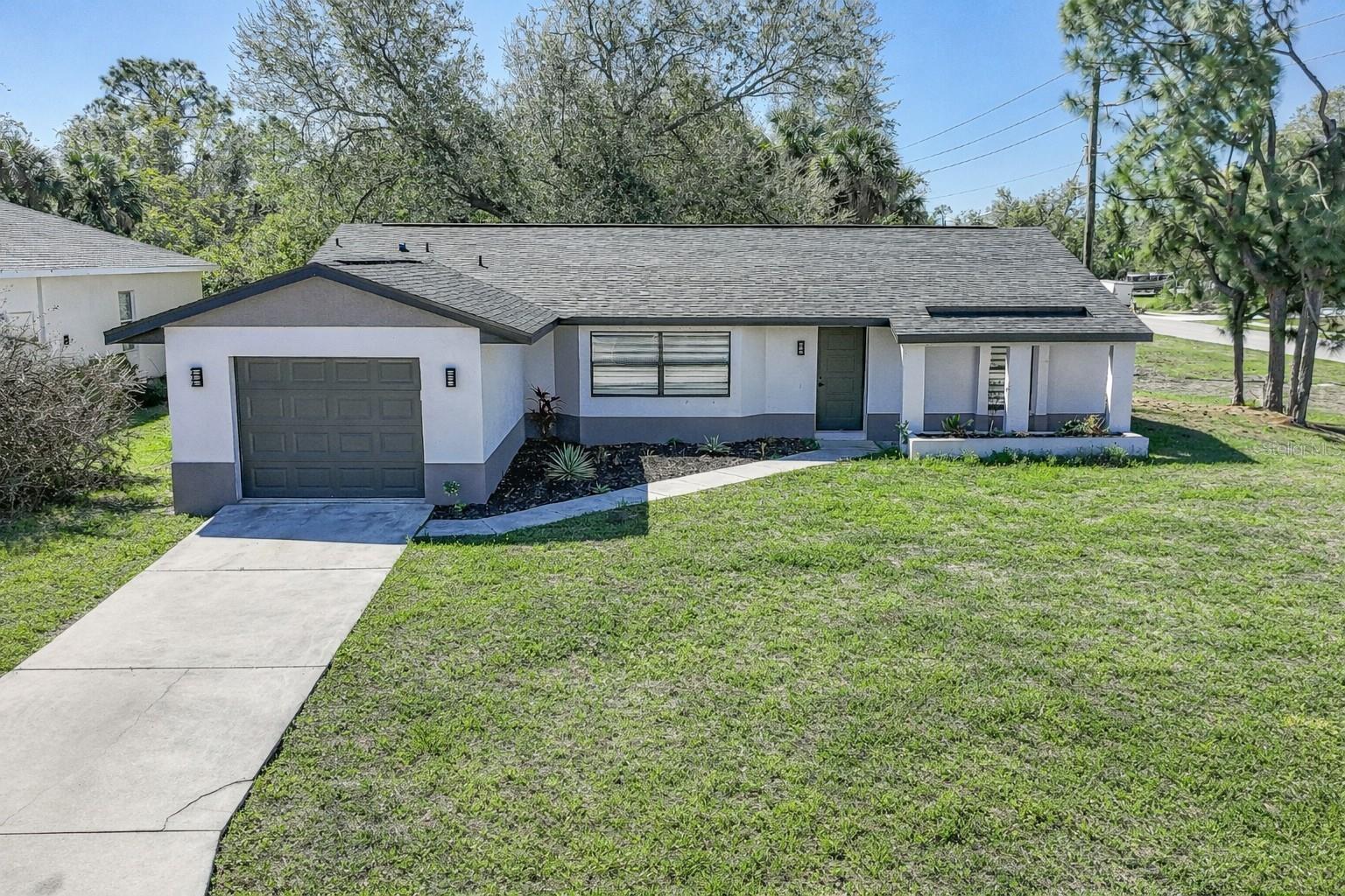 FULLY RENOVATED, MOVE-IN READY, AND PACKED WITH UPGRADES — THIS NORTH PORT HOME IS THE ONE YOU’VE BEEN WAITING FOR. From the moment you step inside, you’ll notice the attention to detail, modern finishes, and thoughtful improvements that make this property stand out from the rest. With MAJOR SYSTEMS UPDATED and stylish upgrades throughout, this home offers the perfect blend of comfort, efficiency, and peace of mind.

The heart of the home is the BEAUTIFULLY UPDATED KITCHEN, featuring NEW CABINETS, STUNNING QUARTZ COUNTERTOPS, UNDER-CABINET LIGHTING, and BRAND-NEW APPLIANCES — creating a sleek, functional space ideal for both everyday living and entertaining. The open feel flows seamlessly into the main living areas, enhanced by NEW LAMINATE FLOORING that runs throughout the home, offering a clean, cohesive, and modern look.

This home has undergone EXTENSIVE UPGRADES, including a NEW ROOF, NEW A/C UNIT, and ALL-NEW A/C DUCTWORK, giving buyers confidence that the big-ticket items have already been taken care of. Additional improvements include NEW SWITCHES, OUTLETS, INTERIOR DOORS, AND A NEW GARAGE DOOR, adding both convenience and value.

Both bathrooms have been COMPLETELY RENOVATED with BEAUTIFUL TILE WORK on the floors and walls, UPDATED VANITIES, MODERN FIXTURES, AND SLEEK FRAMELESS GLASS SHOWER DOORS — delivering a fresh, spa-like feel.

Step outside to enjoy the UPDATED BACK PORCH, featuring NEW TILE FLOORING, making it the perfect space to relax, unwind, or entertain guests while enjoying the Florida lifestyle.

Located in the growing community of North Port and connected to CITY WATER, this home offers both modern upgrades and everyday convenience. Whether you’re a first-time buyer, seasonal resident, or investor, this property is truly MOVE-IN READY with NOTHING LEFT TO DO.

DON’T MISS YOUR OPPORTUNITY TO OWN A FULLY UPDATED HOME WITH ALL THE HARD WORK ALREADY DONE — JUST MOVE IN AND ENJOY.