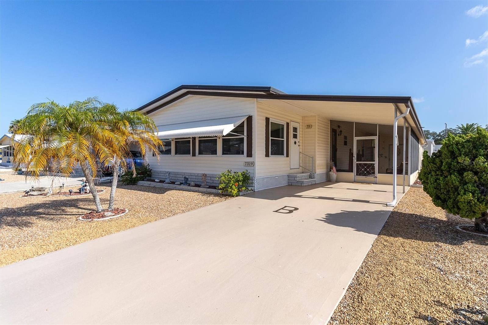 FULLY FURNISHED and move-in ready! You own the land, NO flood insurance is required, and low HOA fees- $250 a year in Ponderosa Park. From the moment you arrive, you will notice the pride of ownership. This immaculate 2-bedroom, 2-bath home has been meticulously maintained and offers an exceptionally spacious floor plan featuring two oversized family rooms, providing endless possibilities for relaxing, entertaining, or hosting family and friends. The bright eat-in kitchen offers plenty of cabinet and countertop space and opens to a separate dining room, creating the perfect layout. Both bathrooms have been beautifully renovated with walk-in showers, while the spacious primary suite features a walk-in closet and private ensuite bath. The oversized guest bedroom easily accommodates two twin beds. One of the home's standout features is the expansive screened-in porch, offering the perfect place to enjoy your morning coffee, read a book, or unwind in the evening. Outside, the low-maintenance stone landscaping means no mowing or lawn maintenance, giving you more time to enjoy the outdoors. The covered carport provides parking for one vehicle, and the property includes two separate sheds—a dedicated laundry/storage building and a second workshop/storage shed, offering incredible space for hobbies, crafts, projects, or additional storage. Buy with confidence knowing many of the major improvements have already been completed, including- roof (2023), 150-amp electrical panel (2023), HVAC system (2021), and replacement windows. Ponderosa Park is a friendly, pet-friendly, 55+ community where you own the land and enjoy outstanding amenities including a swimming pool, shuffleboard courts, and an active clubhouse with year-round social events. Conveniently located near shopping, restaurants, medical facilities, golf courses, parks, and the Gulf beaches, this turn-key home is ready for you to move in and start enjoying the Florida lifestyle from day one.