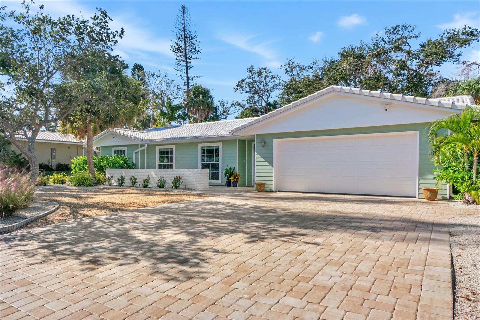 One or more photo(s) has been virtually staged. Nestled near the gentle waters of Roberts Bay, this enchanting Siesta Key home rests on a quiet cul de sac street where the only sounds are the whisper of palms and the laughter of neighbors walking by. T location captures the essence of island life — peaceful, private, and just moments from where the sun dips into the Gulf. A short stroll or quick bike or golf cart ride has you in the center of vibrant Siesta Key. This home is dependable and offers new hurricane impact-rated windows, garage door and sliders; re-lined plumbing lines as well as new pex water supply lines throughout; and a new HVAC system and water heater.
Step inside, and you’ll feel the warmth of a home that’s been lovingly renewed. Every detail reflects care and comfort — from the four inviting bedrooms and two full baths to the light-filled kitchen adorned with stainless steel appliances and a captivating blue glass tile backsplash reminiscent of the Gulf waters just moments from your front door. The dining area invites long, easy meals, while two separate living spaces offer versatility for gathering, relaxing, or simply enjoying the rhythm of coastal living. Life is low maintenance and carefree with durable lvp flooring that looks modern and will compliment your coastal décor.
Beyond the back door lies a spacious, fenced yard — a blank canvas waiting for your imagination. Picture a pool glimmering under the afternoon sun, a lush garden framed with tropical blooms, or a firepit where evenings stretch into starlit conversations. Here, you aren’t confined to someone else’s vision — you have the freedom to create your own perfect oasis suited to your tastes and dreamy outdoor vibe.
The charming front porch welcomes your guests — a cheerful prelude to the life that awaits within. New hurricane-rated windows offer confidence and calm, while the spacious two-car garage with smart epoxy flooring and the generous, indoor laundry room offers convience.
This is more than a house; it’s a fresh beginning on Siesta Key — a place where your coastal dream can take root.