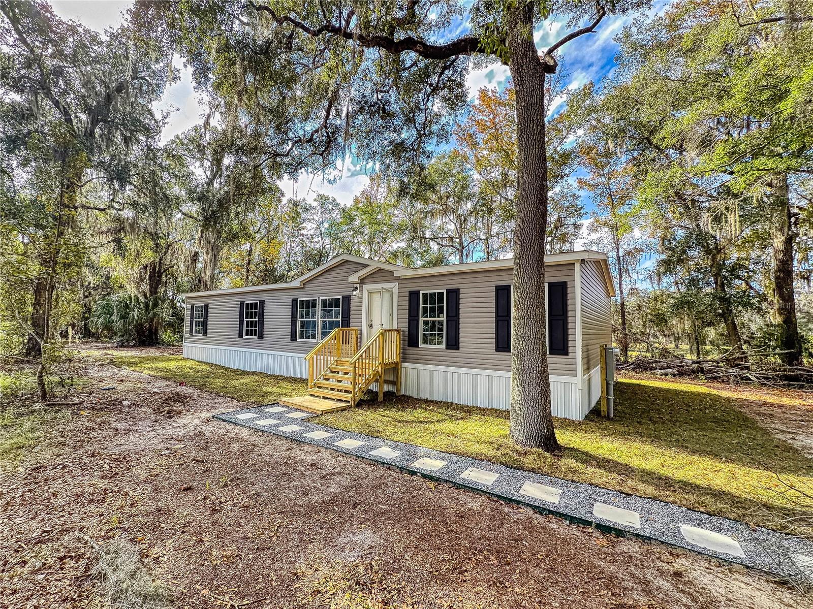 **Price just improved** Owner will assist with closing cost! Looking for a peaceful country retreat, this beautiful spacious 3-bedroom, 2-bath home offers a cozy kitchen and living room. A great master bathroom. Featuring an open floor plan, fresh paint throughout, new carpet, and brand-new stainless-steel appliances, this home is move-in ready. 
Enjoy lower utility costs with a new well and septic system. Bring your toys and your animals to enjoy on 1.25 acres of beautiful nature in Marion County. 
Whether you’re seeking a winter getaway or a year-round residence, this serene estate is the perfect choice.
Don’t wait—priced to sell schedule a showing today and let us help you make it home!