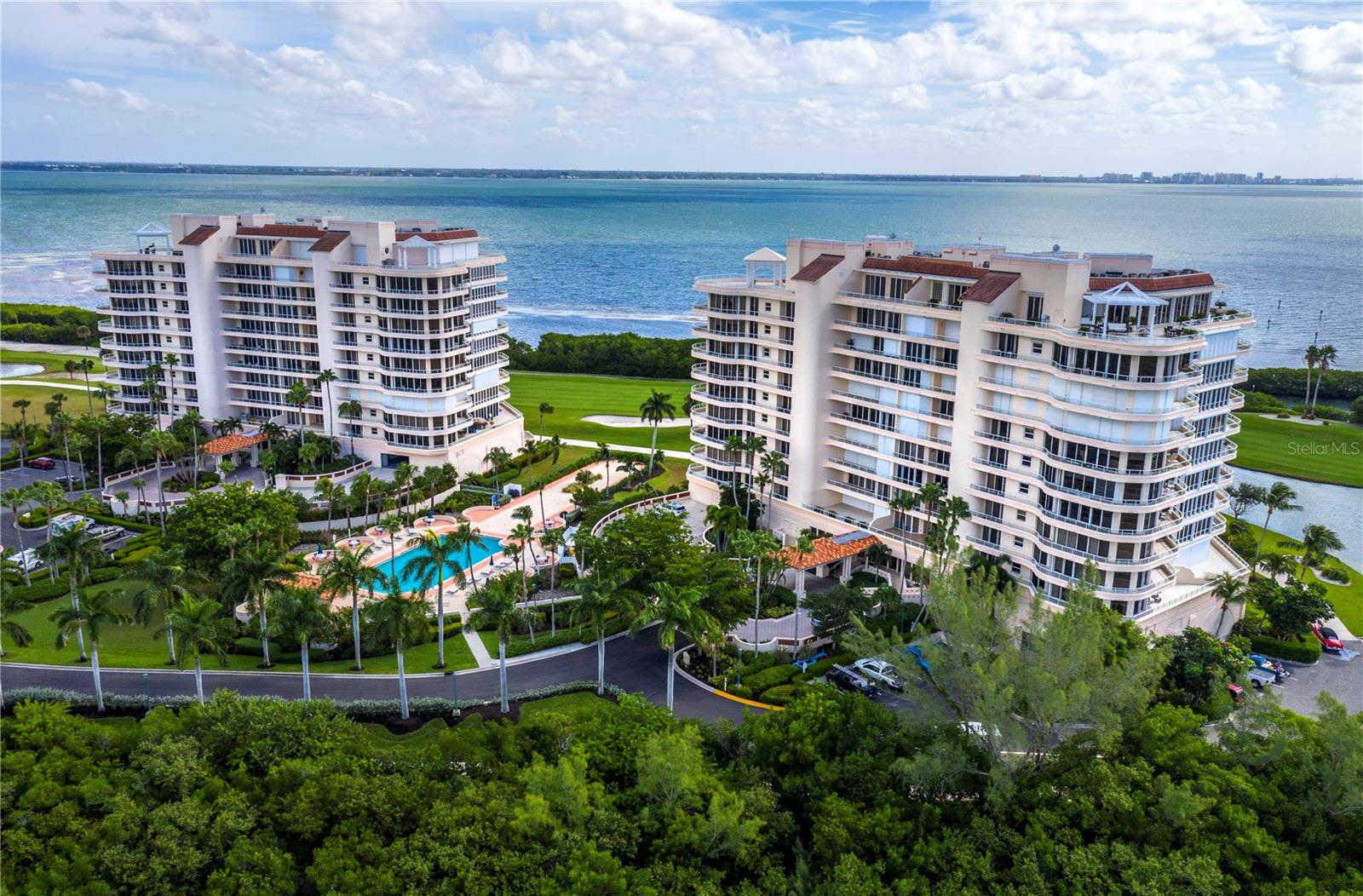 Located in the Grand Bay community on Longboat Key, this spacious 3BR residence offers stunning views and desirable extras, including 2 conveniently located parking spaces. The pet friendly community allows up to 2 large dogs. The home features luxury vinyl flooring and neutral tones throughout, with floor-to-ceiling windows and plantation shutters that let in natural light. Elevated ceilings and accent lighting create an open, airy feel, while you enjoy views of Harbourside Golf Course, Sarasota Bay, and the downtown skyline from the expansive wraparound terrace that is perfect for entertaining or relaxing. The updated kitchen includes white cabinetry, Corian countertops, tile backsplash, stainless steel appliances, including a Sub-Zero refrigerator, and a central island. The living room/dining room offers ample space for a formal dining room table and large seating area. The primary suite is a private retreat, with access to the terrace and newly enhanced sightlines from the bedroom showcasing beautiful views of the Longboat Key Club golf course and Sarasota Bay. The primary bath features dual vanities, a walk-in shower, and a spa tub. The large custom closet is thoughtfully designed for ample storage. A full-size laundry room adds convenience. Grand Bay offers resort-style amenities including 24-hour gated security, a clubhouse with a library and game room, fitness center, 2 Har-Tru tennis courts, 2 heated pools, and a spa. Residents also enjoy deeded beach access through the Bay Isles Beach Club, just a short bike ride away. This private beach offers a peaceful, uncrowded environment, with a beachside pavilion, restrooms, and showers. Additionally, for those seeking more exclusive amenities, the optional Longboat Key Club provides access to luxury services, including golf, fine dining, a full-service spa, and fitness facilities.