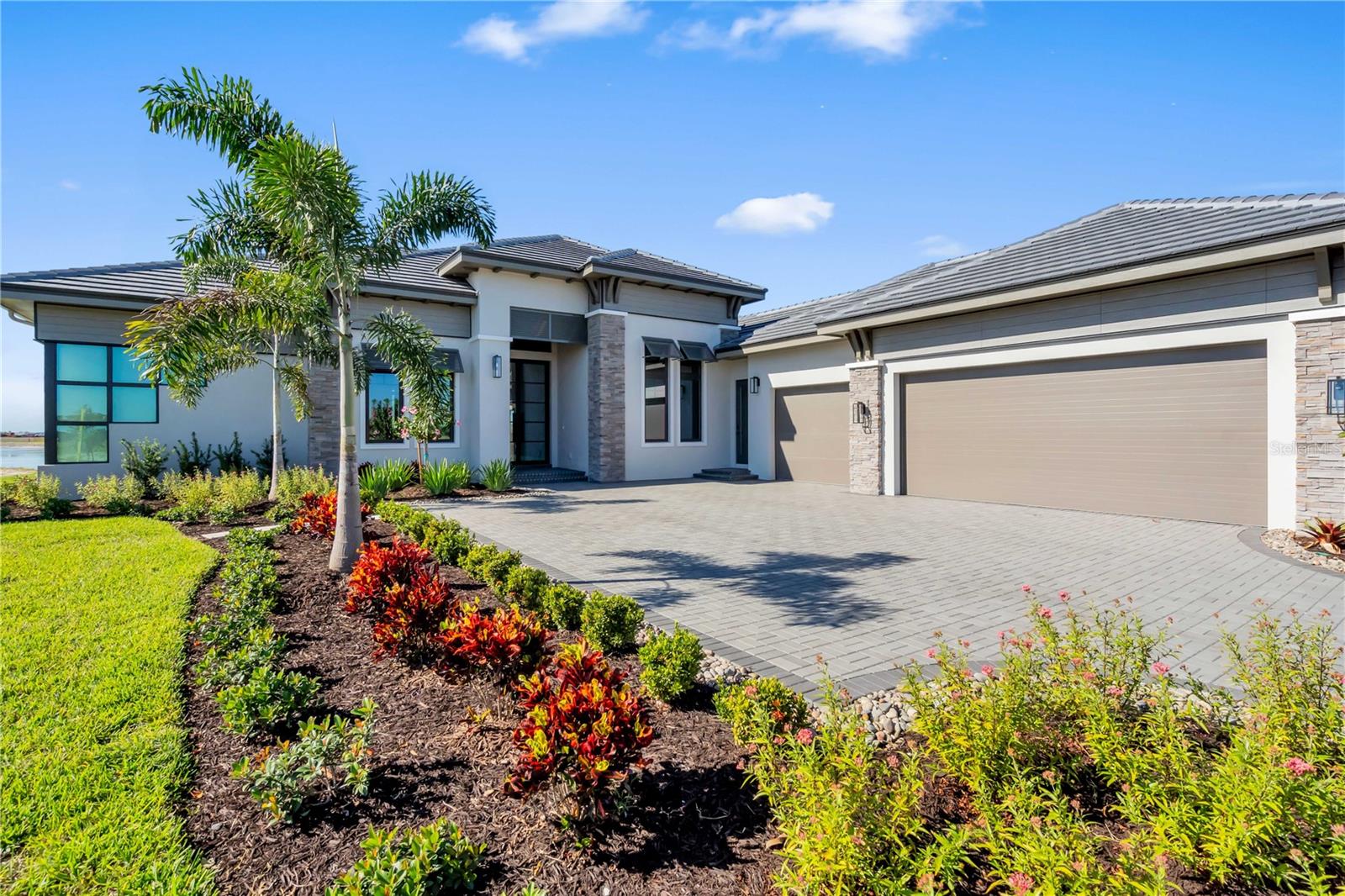 Experience elevated waterfront living in The Wild Blue Showcase Home by John Cannon Homes, a stunning, custom-designed residence located in the exclusive Wild Blue at Waterside in Lakewood Ranch. Situated on a spacious homesite, this 3,782 sq. ft. home offers 4 bedrooms, 5 bathrooms, a private casita, and a versatile bonus room. A thoughtfully crafted floor plan blends sophisticated design with effortless livability—from the chef-inspired kitchen with an oversized island and walk-in pantry to the expansive great room and luxurious owner’s suite with a spa-like bath. Outdoor living takes center stage with a generously sized lanai, ideal for relaxing, entertaining, or enjoying Florida’s year-round sunshine. 
In addition, Wild Blue offers a vibrant, amenity-rich lifestyle with 6 tennis courts, 8 pickleball courts, basketball court, event lawn, dog parks, shaded pavilions, lakeside trails, a kayak launch, children’s playground, and outdoor fitness areas. Just beyond, residents also enjoy convenient access to Midway Sports Complex, featuring 13 acres of open green space, athletic fields, and community gathering areas. Whether you're exploring boardwalks through natural wetlands or enjoying a lakeside picnic, The Wild Blue Showcase Home by John Cannon Homes is your gateway to luxury living with an active, connected lifestyle in one of Southwest Florida’s premier master-planned communities. Wild Blue offers luxury living in the heart of Lakewood Ranch with exceptional amenities for all ages. The new clubhouse (under construction) will feature concierge service, private theater, fitness center, golf simulator, billiards room, and two resort-style pools, plus a future full-service restaurant and patio bar. Ideally located near UTC, Waterside Place, and top dining and shopping, Wild Blue delivers an elevated lifestyle in a premier LWR community.