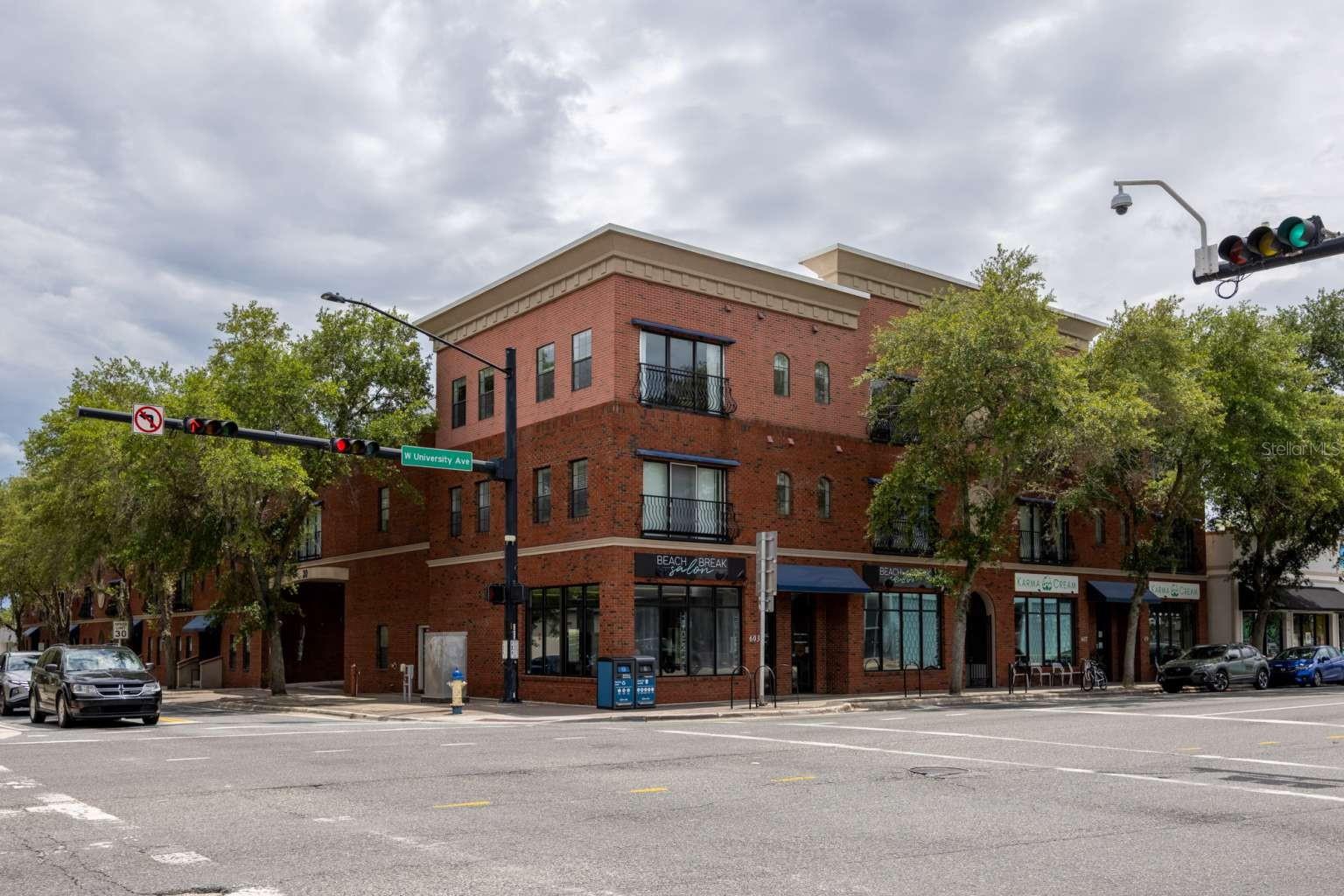 Ideally situated between the University of Florida and vibrant Downtown Gainesville, this 836 sq ft second-floor condo puts you within easy walking distance of campus, Midtown restaurants and bars, Ben Hill Griffin Stadium, and the heart of downtown, with Shands Hospital less than two miles away as well. Main windows face east toward downtown, filling the unit with natural light. Inside, a thoughtfully designed floor plan pairs an open, modern kitchen with a spacious living area, creating an inviting space for relaxing or entertaining. One large bedroom is complemented by a versatile office/study with its own walk-in closet, easily used as a second bedroom, guest room, or home office. A stackable washer and dryer are included for added convenience, along with a fire sprinkler system and crown molding throughout. One assigned parking space comes with the unit in the community lot, with additional on-street city parking nearby (fees apply). Whether you're looking to move in or hold as an investment, this centrally located condo offers a flexible opportunity in one of Gainesville's most walkable neighborhoods.