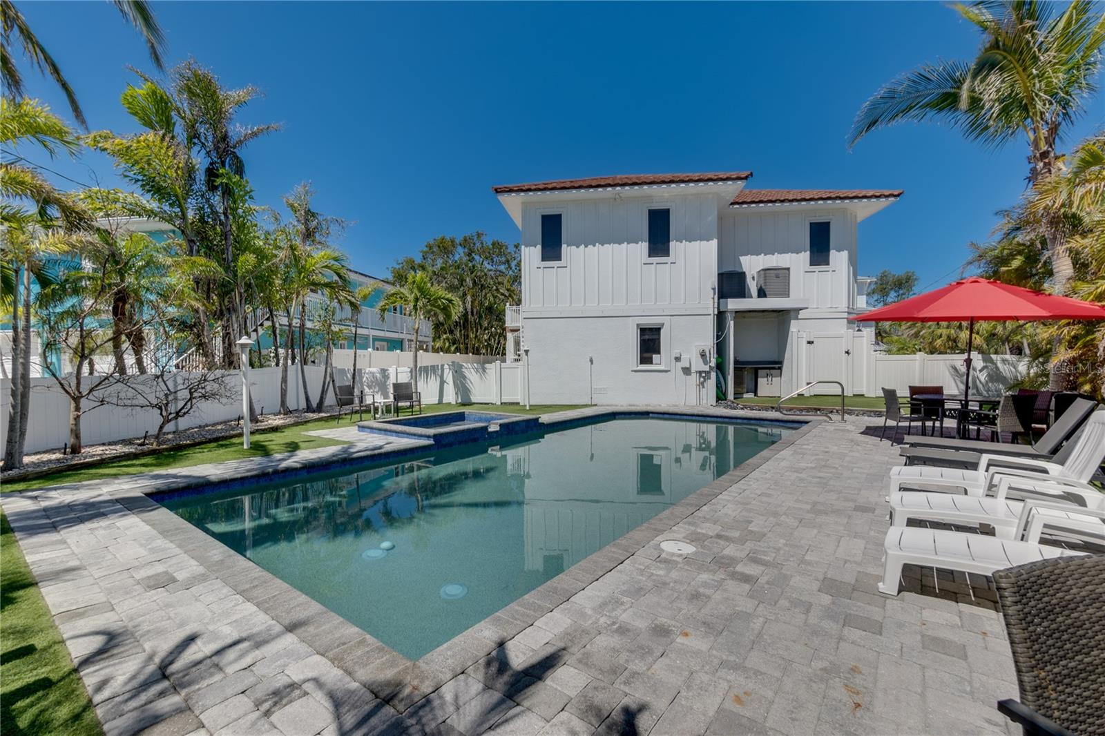 Welcome to 803 Gladiolus St, a serene retreat located in the highly desirable Bean Point area of Anna Maria Island. Often referred to as A Bean Point Paradise, this exceptional property features one of the largest private pools on the island, surrounded by lush tropical landscaping and a relaxing spa.

This versatile home is ideal as a primary residence, second home, or vacation rental. A Burt Harris Settlement Agreement allows occupancy for up to 12 guests, offering rare flexibility and strong rental potential.

Property Details

Bedrooms: 5

Bathrooms: 4.5

Parking: Accommodates up to 6 vehicles with oversized parking and space for a boat trailer — a rare feature compared to most homes on Anna Maria Island

Location: Approximately a five-minute walk to the Gulf beaches at Bean Point

Exterior Features

Enjoy a private tropical backyard designed for entertaining, complete with an expansive pool and spa. Outdoor amenities include a BBQ grill and poolside refrigerator, perfect for al fresco dining. Conveniently located near beaches, shopping, and local restaurants.

Interior Features

The home offers an open and inviting living area with ample seating, a chef’s kitchen with stainless steel appliances, a large island, and a formal dining area. Multiple indoor and outdoor dining options enhance the home’s flexibility for both everyday living and entertaining.

Floor Plan

Second Floor: Three bedrooms

Third Floor: Primary suite plus one additional bedroom

Den: Queen sleeper sofa for additional guest accommodations

Balconies: Off the living room and primary bedroom

Additional Features

The converted garage has been transformed into a dedicated game room, complete with a ping-pong table, foosball, seating, and a TV—creating a fun and functional space for guests of all ages while enhancing the home’s rental appeal.

Remarks

803 Gladiolus St offers a rare combination of generous parking, a resort-style backyard, a prime Bean Point location, and a bonus game room rarely found on Anna Maria Island. A unique opportunity to own a well-appointed island property with exceptional lifestyle and income potential.