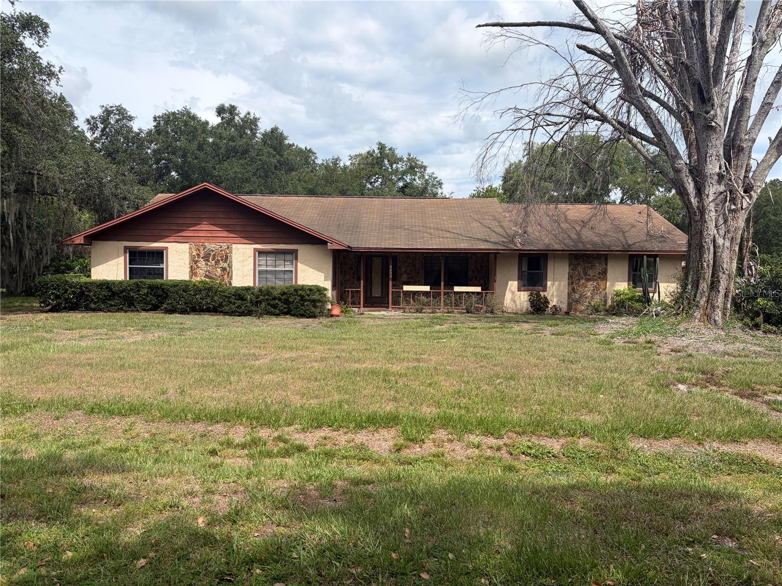 Nestled on a spacious 0.5-acre lot with an in-ground pool, this solid Winter Haven home balances completed improvements with an opportunity to add your own personal updates. A stunning converted family room boasts a natural wood interior, full wet bar, and an open layout, while a separate detached 2-car garage provides ample parking. Enjoy a cozy living area with a brick fireplace and built-in bookshelf. The large master suite features a walk-in closet and a jacuzzi tub. With extensive storage, a large cabinet-packed kitchen, and an optional HOA, this home is ready for your vision!