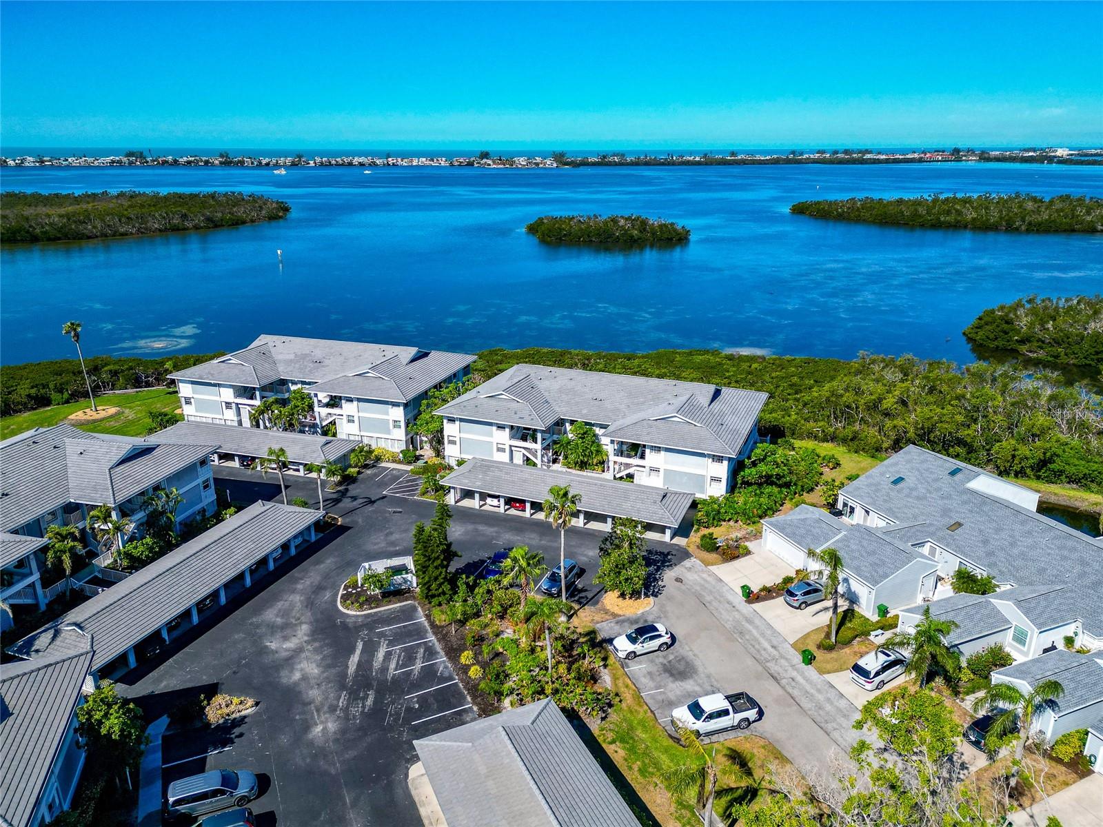 ASSOCIATION DUES WENT DOWN!  Spectacular Sunsets & Big Water Views Of Anna Maria Sound Will Take Your Breath Away!!  This Very Private Elegantly Updated 2-Bedroom/2 Bathroom Home In The Highly Sought-After Gated Community of Perico Bay Club Offers The Perfect Blend of Style, Comfort, And Convenience To The Renowned Beaches of Anna Maria Island. Step Inside This Beautifully Updated Home And Watch How The Vaulted Ceilings Take Your Eyes Straight Out To The Big Open Water View! Watching Florida Sealife And Spectacular Sunsets From A Front Row Seat On Your Own Lanai - Priceless! After You Come To Your Senses, You’ll Enjoy Seeing The Beautifully Updated Kitchen With Stainless Appliances, Lovely Baths And The Spacious Living Room, Eat-In Kitchen, And Dining Area With Ceramic Plank Tile Throughout. A Second Bedroom Providing Ample Space For Friends Or Family, This IS The Perfect Place For Entertaining Or Relaxing. This Lovely Home Can Be Found Tucked Back In Beautiful Resort Style Gated Perico Bay Club With Winding Roads Around Several Lakes Highlighting Professionally Landscaped Grounds With Sidewalks And Benches To Watch The Waterbirds Play. There’s A Pool Close By And An Olympic Pool At The Clubhouse. Kayak Storage And Launch, A Well-Equipped Gym, Tennis & Pickleball Courts, New West Facing Boardwalk And All Close To Robinson Preserve, Neal Preserve And A Bicycle Ride To Anna Maria Island. Close To Shopping And Restaurants, It’s The Lifestyle You’ve Been Waiting For! Call Today For Your Personal Tour To Make It Yours!
