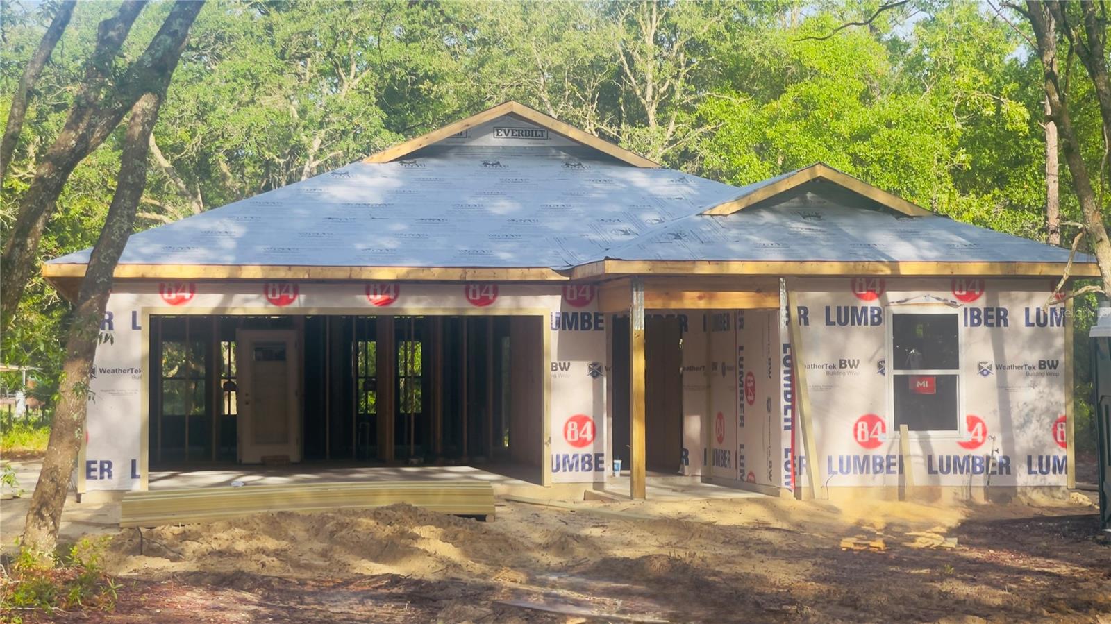 Under Construction. Under Construction. Interior photos are from a previous model and colors may be different. This cute & cozy 3 bedroom, 2 bath home sitting on a spacious 1.25 acre lot on paved county street offers quality craftsmanship with modern finishes. The interior features granite countertops, under-mount sinks, soft-close wood cabinetry, and a stainless-steel appliance package. Decorative tray ceilings with crown molding, luxury vinyl plank flooring throughout the main living areas, carpeted bedrooms, and updated fixtures contribute to the home's cohesive design. Large windows allow natural light to flow throughout the living spaces, creating a bright interior environment. The floor plan offers comfortable bedroom sizes and ample closet storage. Outside, the covered rear porch provides a place to enjoy the surrounding landscape, while mature trees offer shade across portions of the property. Plenty of space outside for animals, gardening, boat storage , etc. This brand new home offers a blend of thoughtful design, functional living space, and located just outside of the city limits. Short drive to schools, shopping, land local amenities while also being an easy commute to Gainesville or Ocala.