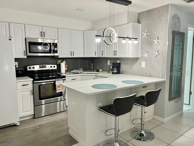 This beautifully updated 1/2 duplex in Clearwater offers a well-appointed 2-bedroom, 2-bathroom rental unit. Each bedroom is complemented by its own private bathroom, offering a level of comfort and separation. The interior has been tastefully updated with attention to detail and has been meticulously maintained.  The unit features a gourmet kitchen with stainless steel appliances, quartz countertops, and white shaker cabinets. Each bathroom comes with a shower. Laminate flooring runs throughout the living areas, complemented by fresh paint for a bright, move-in ready feel. Your private laundry is located inside the unit.  The fenced backyard with 3 separate sitting areas provide privacy and space for outdoor activities.  Water and landscaping maintenance are included in your rent payment. Located in a centralized area close to everything—just 20 minutes to world-famous sandy beaches, 15 minutes to Tampa International Airport, 15 minutes to St. Pete–Clearwater Airport, 10 minutes to Tampa Bay, and minutes from shopping, dining, entertainment, malls, and more. Contact us today to schedule your private showing.