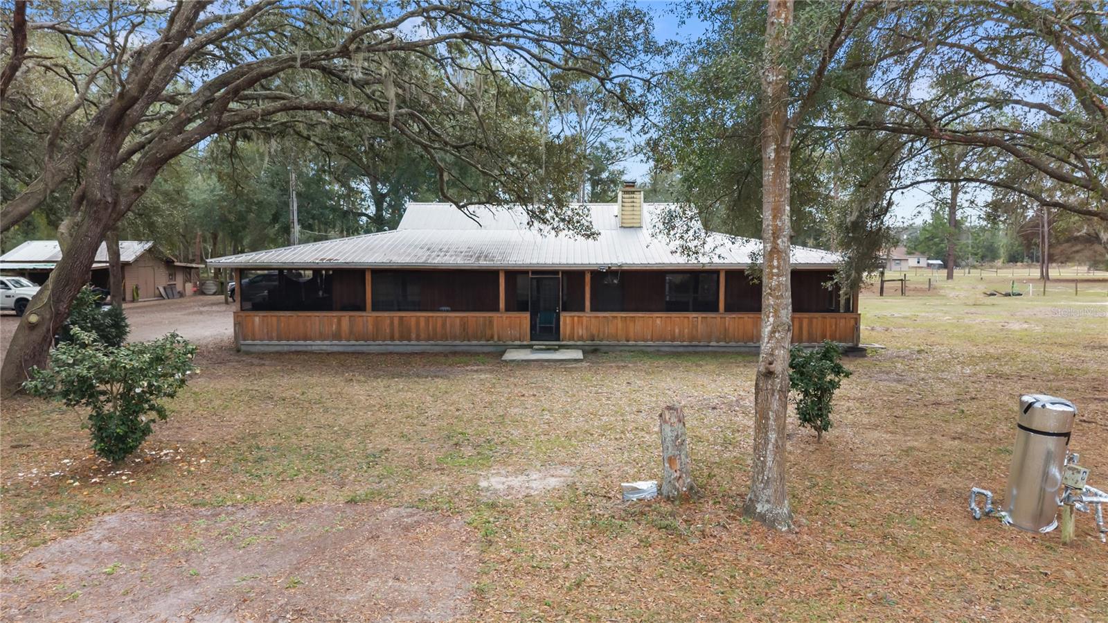 NO HOA! Situated on 6.85 acres across three separate parcels, this 3-bedroom, 2-bath property offers the perfect combination of privacy, functionality, and location. Ideal for horse enthusiasts, the property is just minutes from HITS Ocala and the World Equestrian Center, with plenty of room for horses, barns, paddocks, and riding areas. The home features energy-saving solar panels, a newer HVAC system, and a durable metal roof. A massive 2,600-square-foot workshop on a concrete slab provides exceptional space for equipment, RV storage, vehicles, hobbies, or a home-based business.
Inside, the home offers comfortable living with a spacious layout designed for everyday living and entertaining. Outside, the expansive acreage provides endless opportunities to create your own equestrian estate, hobby farm, or private country retreat while still being conveniently located near shopping, dining, medical facilities, and the crystal-clear Rainbow River, with easy access to Ocala, Gainesville, and Florida's Gulf Coast.