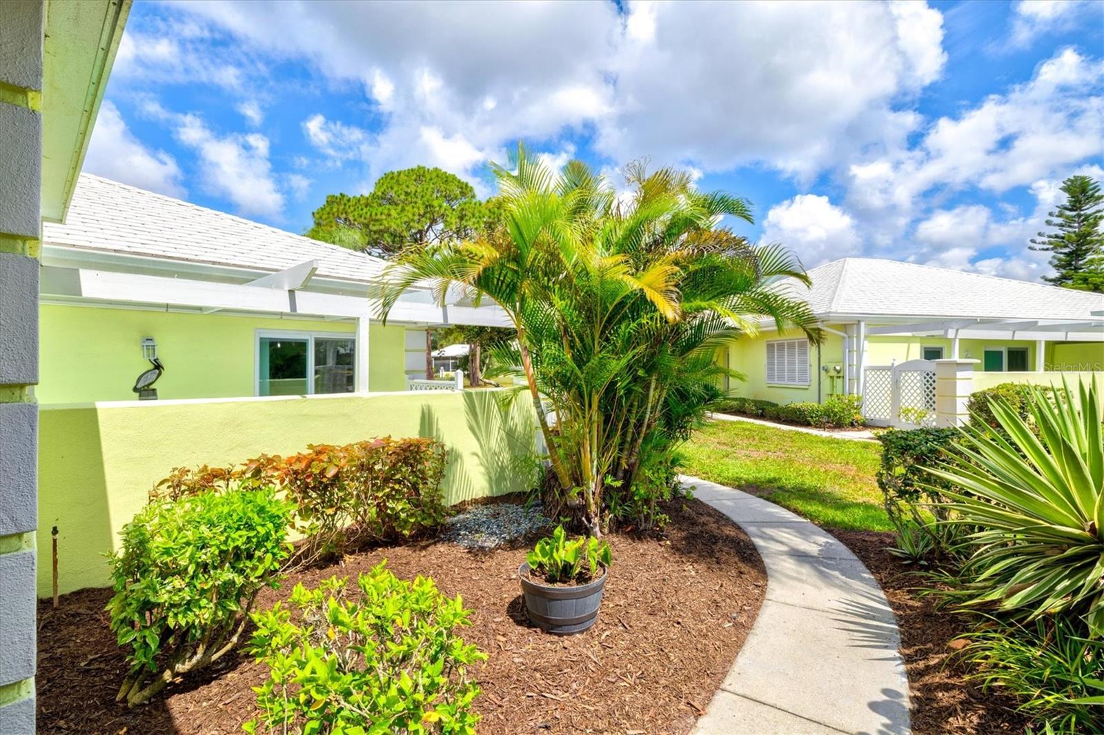 Step into luxury with this completely updated, turnkey 2-bedroom, 2-bathroom villa in Augusta Villas at The Plantation. Ready for immediate enjoyment, this beautifully furnished home includes everything you see and offers breathtaking lake and golf course views from nearly every room, creating the perfect blend of modern elegance and tranquil surroundings.
Designed for comfort and privacy, the villa features dual primary suites, each with its own en-suite bathroom and sliding glass doors leading to outdoor living spaces. Recent upgrades include 2024 impact windows and sliders, custom window treatments, stainless steel appliances, soft-close cabinetry, sleek quartz countertops, and a 2025 washer and dryer. The new A/C provides year-round comfort, while the main ductwork was replaced in January 2023. Additional updates include a 2019 water heater.
Enjoy Florida living at its finest in the private courtyard, accessible through sliding glass doors and perfect for outdoor dining, entertaining, or grilling. A separate laundry and storage room adds convenience, while recent exterior improvements include a newer roof and carport.
Located in a vibrant, non-age-restricted community just minutes from The Plantation clubhouse, residents enjoy access to golf, tennis, pickleball, a resort-style pool, dining, and an active social calendar. Membership is available but not mandatory and requires a separate fee.
Ideally situated near Wellen Park, Historic Venice Island, and the Gulf Coast's beautiful beaches, this villa offers the ultimate Florida lifestyle. HOA amenities include cable TV, community pool, exterior maintenance and repairs, professional management, pest control, pool maintenance, private roads, and trash service for truly worry-free living.