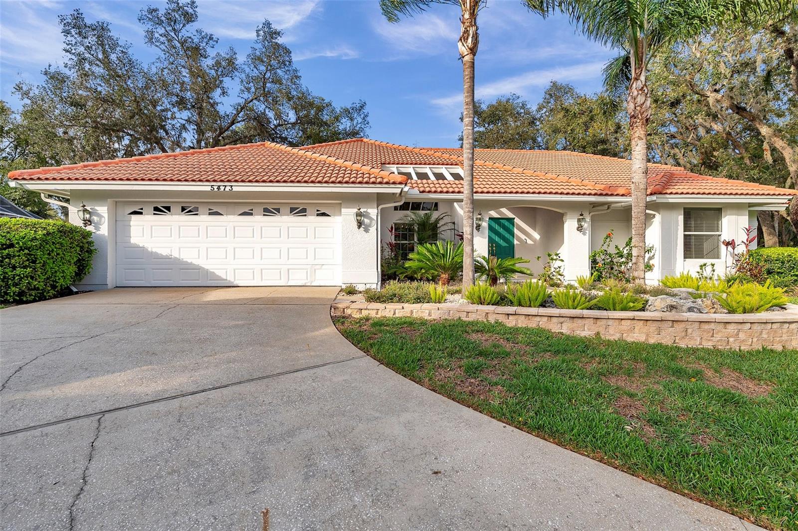 Here is your beautiful home—your chance to own a single-family property in the highly desirable Saddlebrook community, comes with beautiful updates.  This impeccably maintained residence provides plenty of space for you and your family, complemented by a large backyard featuring lush landscaping, mature trees, and more than enough room to build a large pool, should you desire to create your own backyard oasis." As you enter through the elegant double doors, you are immediately greeted by soaring ceilings and an open, inviting floor plan. The spacious dining and living room combination features a charming decorative mantel and large sliding doors that open to the tranquil back porch, perfect for relaxing or entertaining. This home includes a highly sought-after split floor plan, ensuring maximum privacy for the homeowners. On the right wing, you'll find the expansive master suite, complete with a luxurious en-suite bath featuring a soaking tub, walk-in shower, and a brand new double vanity. (2026) The master bath also includes a spacious walk-in closet. On the opposite side of the home, two additional large bedrooms and a fully updated beautiful bathroom with a shower(2026) provide plenty of space for family or guests. At the heart of the home, the beautiful kitchen is, equipped with granite countertops, shaker cabinets, a gas range, and a central island with a breakfast bar. The kitchen features updated stainless steel appliances, including a new fridge and dishwasher (2022). The open concept design seamlessly flows into the family room, creating the perfect space for daily living and entertaining. Step outside to the picturesque backyard with a screened-in porch, providing a peaceful retreat after a busy day. This outdoor oasis is perfect for gatherings, with ample space for family and friends to enjoy. he home features several recent upgrades, including a brand-new gas tankless water heater (2024), new A/C system (2022), brand new vanities in both bathrooms, (2026) brand new walk in shower in the guest bathroom (2026)and enhanced landscaping with mature shrubs, new plants, and decorative stones around the perimeter. There is also ADT security system and video door bell included. Living in Saddlebrook Resort will elevate your lifestyle with its exceptional amenities. The resort boasts three 9-hole championship golf courses, 45 professional tennis courts, pickleball courts, three swimming pools, a European health spa, three excellent restaurants, a fitness center, and much more. The community is gated with 24/7 security, providing peace of mind for its residents. Enjoy dining at the resort hotel while taking in beautiful views of the golf course and natural trails, perfect for sipping your morning coffee. Saddlebrook is conveniently located just minutes from Wiregrass Mall, Tampa Premium Outlets, The Grove, St. Leo University, the USF campus, and both Lagoons. With quick access to I-75, you’ll find world-famous beaches, Tampa International Airport, Busch Gardens, hospitals, schools, and recreational centers all within reach. A membership is required to use the amenities at Saddlebrook, which include the swimming pool, fitness center, and tennis courts and golf. you can enjoy the community’s beautiful natural habitat, walking or running among the wildlife and cypress trees. The location is also fantastic—close to restaurants, schools, hospitals, shopping and dining in the booming town of Wesley Chapel. Call today to schedule your viewing