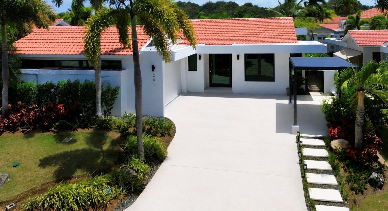 This fully reimagined Villa Carbia offers 3,950 interior square feet of space, flow, and function unlike anything else available on the market. Designed by Attiko, this fully furnished smart home seamlessly blends automation with a turnkey lifestyle, thoughtfully crafted from top to bottom. Five bedrooms, five full baths, two half baths, a wet bar, and a private office are complemented by Lutron shades throughout, adding effortless comfort. Step into a beautiful kitchen with Sub Zero and Wolf appliances, an induction cooktop, vented exterior hood and pantry. The primary suite is a retreat of its own, featuring a tub and walk in shower that opens directly to the exterior, leading to a heated pool with bubble jets and an outdoor entertainment area and kitchen, perfect for indoor outdoor living. This home is also built for resilience and independence, with a premium G-Cool Airmaster window package designed to significantly reduce sunrays and heat, solar panels, two 13.5 kWh Tesla Powerwalls, a water cistern, solar water heater, inverter A/C, and a camera security system. Must be seen in person. Decorations and artwork not included. Seller financing available. Reach out to schedule your private showing.