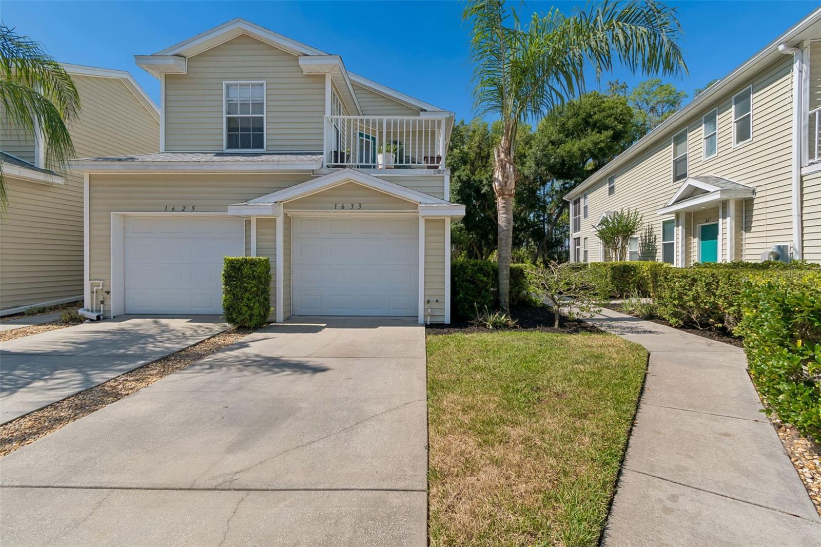 Welcome to effortless Florida living in the gated community of Lakes at Heron Cove. This stylish, well-maintained 3-bedroom, 2-bath condo offers 1,624 square feet of thoughtfully designed living space along with a 1-car attached garage—a rare find at this price point. The desirable split-bedroom floor plan provides privacy and comfort, while the open living areas are ideal for everyday living and entertaining. Step outside to your private screened lanai, where tranquil conservation and lake views create the perfect backdrop for morning coffee or evening relaxation as local wildlife passes by. Inside, the kitchen is both functional and inviting, featuring wood cabinetry, ample counter space, a breakfast bar and closet pantry. The spacious primary suite (15x13) includes a walk-in closet and an en-suite bath with dual vanities, and a private water closet. Recent updates add peace of mind, including NEW HVAC in 2025 and a NEW ROOF completed by the association in 2021. Enjoy NO CDD fees and a low monthly HOA of just $325, making this an affordable and low-maintenance option. Community amenities elevate the lifestyle: a sparkling resort-style pool, clubhouse, scenic walking paths, and direct access to 54-acre Lake Bird with a boat ramp and fishing dock—perfect for small boats, kayaks, or peaceful afternoons by the water. Tucked away behind mature trees yet conveniently located off Hwy 54, this community offers easy commuting with quick access to I-275, shopping, dining, and entertainment just minutes away. USF, Moffitt Cancer Center, and Downtown Tampa are all within a 20–30 minute drive.