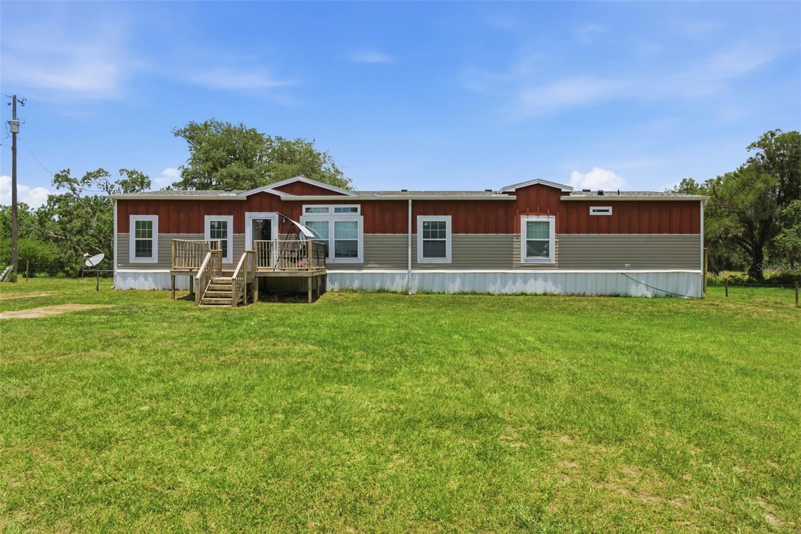 Escape to the peaceful country lifestyle you've been dreaming of with this spacious 4-bedroom, 2-bathroom manufactured home situated on 4.40 private acres. Designed with both comfort and functionality in mind, this inviting home features separate living areas, a cozy wood-burning fireplace, and an oversized laundry room with ample space for storage and organization.

At the heart of the home is a beautifully appointed kitchen featuring an expansive center island perfect for meal preparation, entertaining, or gathering with family and friends. An abundance of cabinetry provides exceptional storage, making the space as practical as it is welcoming. The generously sized primary suite serves as a private retreat, complete with a sprawling ensuite bathroom and an impressive walk-in closet. The thoughtful layout offers flexibility for families, guests, or multigenerational living.

Step outside and enjoy the property's many outdoor amenities, including a gazebo, utility shed, and RV hookup, making it ideal for recreation, visitors, or additional living arrangements. Adding to the appeal, the roof was replaced in 2025 and the HVAC system was updated in 2022, providing peace of mind for years to come.

Nature lovers will appreciate that the property backs directly to the Withlacoochee State Forest, offering a serene backdrop and the assurance that no future development can be built behind the home. With exceptional family compound potential and the neighboring property also currently available for purchase, this is a rare opportunity to create a private multi-home estate for extended family, investment purposes, or future expansion.

Enjoy the tranquility of country living while still being conveniently located near shopping, dining, and everyday conveniences.
