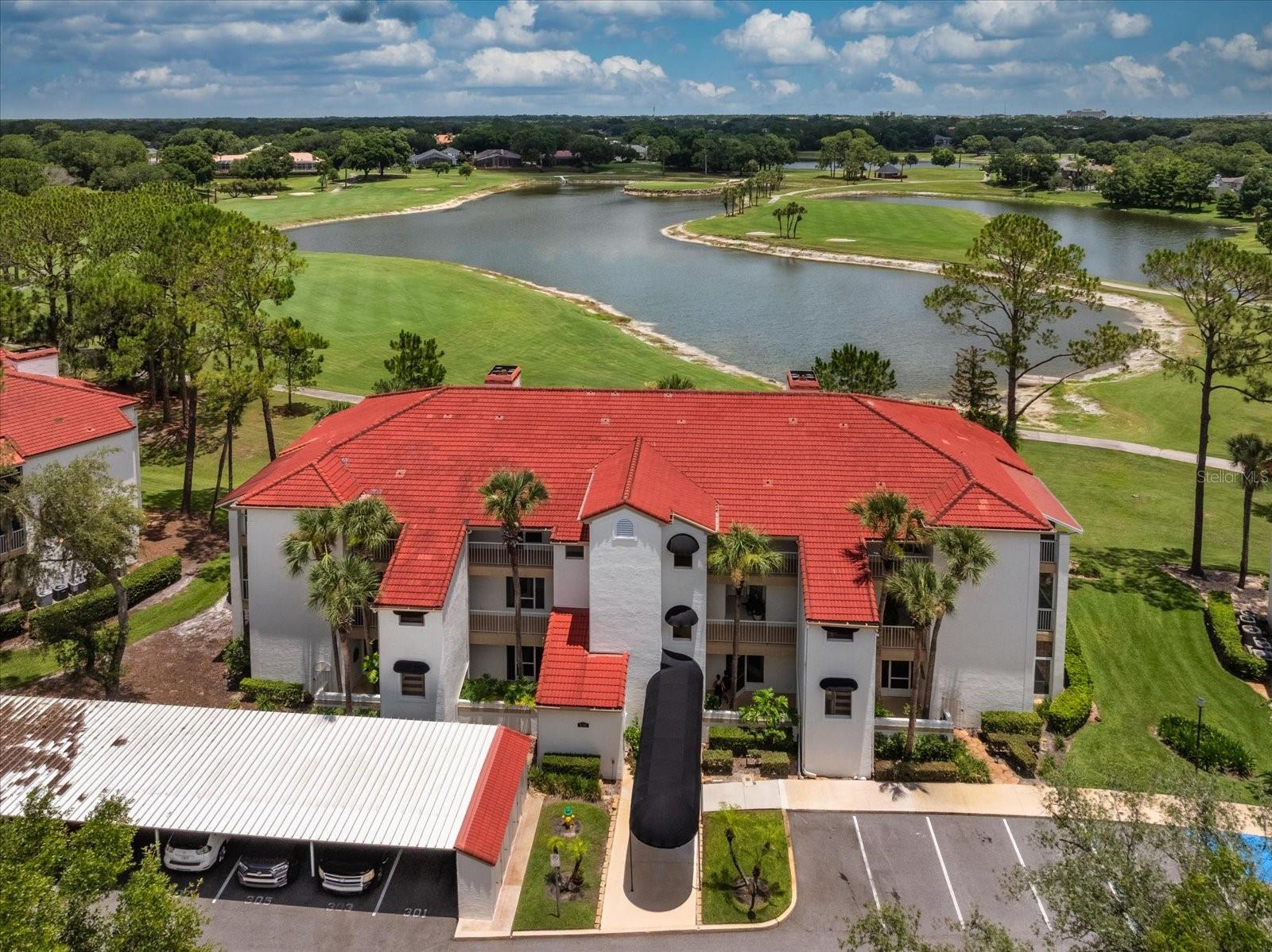 A rare find..FIRST FLOOR CONDO that you will not find a better view of the Golf course and water in Heathrow. This condo OVERLOOKS the 11th Hole and 12th ISLAND GREEN, and offers a RESORT FEEL as you sit on your OVERSIZED SCREEN PATIO enjoying your morning coffee or favorite beverage. The Condo is a 2 BEDROOM, 2 FULL BATHS, with A SPLIT FLOOR PLAN for privacy. The minute you walk in you will notice the UPSCALE FEATURES OF TRAVERTINE FLOORING throughout the condo, CROWN MOLDING, NATURAL LIGHTING. UPDATED LIGHTING, COZY FIREPLACE, The kitchen is one that is a cooks dream. Completely updated with STAINLESS APPLIANCES, GRANITE COUNTERTOPS, and room for a EAT-IN AREA for a small table. THE DINING AREA has a extended Granite Countertop from the kitchen for your Bar Stools and enjoying coffee and reading. The Living room is oversized with a Wood Burning Fireplace, and gorgeous views of the Golf Course an lake. Walk into your Primary Suite that also offers a PRIVATE PATIO ENTRANCE. This Primary suite has a OVERSIZED WALK IN CLOSET, DUAL VANITIES, GRANITE COUNTERTOPS, SHOWER W/ JETTED BATH TUB COMBINATION. The GUEST BATH has a WALK-IN SHOWER WITH A SPA FEEL, GRANITE COUNTERTOP. The HAMPTONS community offers you a DESIGNATED PARKING SPOT (103) and a small ATTACHED STORAGE UNIT. The HOA INCLUDES;  Maintenance free lifestyle that covers Outdoor Maintenance & Landscaping, Exterior Insurance, Pest Control, Trash, Water & Sewer, New Elevators, Private resident Pool and newly updated Clubhouse with a State of the Art Fitness Center with Kitchen and Dining area to gather with your Friends and Family. Hampton's Assessments and inspections are complete! HEATHROW HOA OFFERS; Upscale Living that has 24/7 Manned Security Guard Gates, Private Street Patrol, SAWYER LAKE COMMUNITY AREA with Fishing Dock, Playground, Lighted Basketball courts, Clubhouse for gatherings as well as open Pavillion perfect for family events. FOR AN ADDITIONAL FEE, you can join the Highly acclaimed Golf Courses of Heathrow Golf & Country Club and Alaqual Legacy Golf Course as well as The New Pickleball Courts and Championship Tennis Facility, The Olympic Swimming pool area  that has a Diving Board, water Slides, Cabana's, Food & Drink Pavillion, The Athletic Facility Fitness center has top rated equipment, Group classes, Personal Trainers. Heathrow is 45 minutes to Beaches, Disney and minutes away from The New Hospitals, Advent Health & Orlando Health, Fine Dining Restaurants, Shopping,