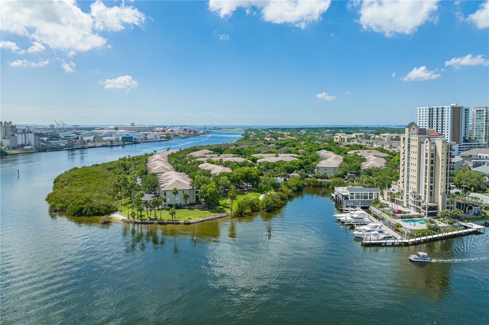 Experience waterfront living in the exclusive, 24-hour guard-gated community of Island Place Residences on Harbour Island. This fully renovated townhome-style condo stands out for its modern, efficient floor plan, 2 bedrooms, 2 baths, and a private 2-car garage, with direct views of Garrison Channel. It's just a short walk to Water Street, Sparkman's Wharf, the Tampa Riverwalk, Downtown Tampa, the Channel District, upscale dining, lively nightlife, and the BIA arena, home to Lightning hockey games and concerts.

Step into this beauty of a residence spanning 1225 square feet across three levels, with every detail thoughtfully curated, designer furniture, and exquisite decor throughout. The spacious living layout features high ceilings, natural light, and a private balcony, offering peaceful views of the Garrison Channel, where cruise ships and boats pass by. Elevated finishes include luxury vinyl flooring, hurricane-impact windows and sliding doors, designer lights, cable railings, custom closets, barn doors, modern finished doors, hurricane-rated garage doors, remote roller shades, electric sheer drapes, LED medicine cabinets, and high-end finishes throughout. 

The open kitchen combines style and functionality, featuring elegant marble countertops and backsplash, extensive custom cabinets, premium stainless-steel appliances, a wine refrigerator, a large single sink, a convection wall oven, an electric cooktop, a sleek range hood, and a reverse osmosis water filtration system. The spacious primary suite features designer double closets, barn doors, and an eye-catching en suite bathroom with a walk-in shower. A flexible guest bedroom has a walk-in closet and a custom storage bed, ideal for guests or a home office. Nearby, a second bathroom with a tub offers a perfect spot to relax. The stackable W/D and tankless water heater are behind two modern bypass doors. Residents enjoy resort-style amenities, including a temperature-controlled pool and heated spa, fitness center, tennis courts, clubhouses, scenic walking paths, kayak access, BBQ areas, valet trash service, and a pet-friendly environment. This exceptional Harbour Island residence offers water views, luxury upgrades, 4 parking spaces, and is located in one of Tampa’s most walkable areas.