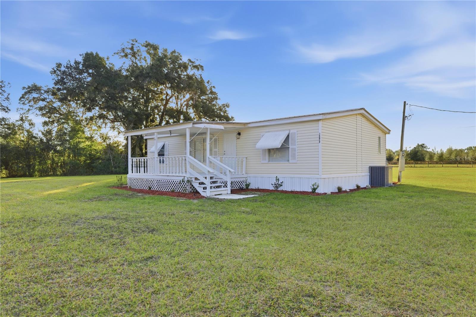 Discover peaceful country living in this beautifully updated home on 3.98 acres, zoned A1 and perfect for horses or hobby farming. The property is mostly fenced and includes pasture spigots, making it easy to bring your animals or outdoor projects to life. Enjoy wide-open space for gardening, recreation, or simply relaxing in a quiet rural setting.

Inside, the home feels bright and welcoming with 2025 updates including new flooring, fresh interior paint, new blinds throughout, and ceiling fans in every room. The kitchen is both stylish and functional, and the comfortable living areas offer plenty of natural light. Additional features include Metal roof, Covered front porch with fresh exterior paint, New landscaping for added curb appeal, Move-in ready condition, Convenient location with easy access to Gainesville, Ocala, and all of Central Florida. A wonderful opportunity to own a turnkey country home with acreage in Marion County—ready for your horses, your hobbies, and your lifestyle.