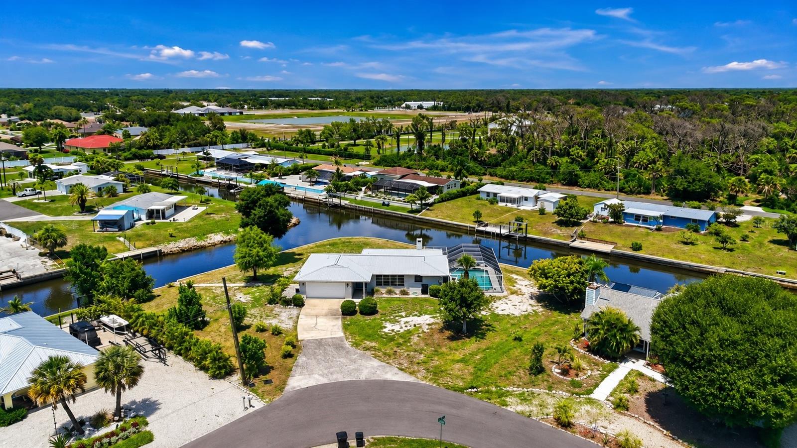 325 FEET OF WATERFRONTAGE | GULF ACCESS | HEATED POOL | NEW DOCK & CONCRETE SEAWALL | NO HOA | BOAT FROM YOUR BACKYARD TO THE GULF! Welcome to your own slice of Old Florida waterfront paradise! Situated on a rare tip lot with approximately 325 feet of waterfrontage on Snook Bayou, this exceptional GULF ACCESS home offers incredible water views, endless privacy, and the opportunity to experience the Florida lifestyle you have been dreaming of. From the moment you arrive, the mature and abundant mango tree welcomes you with true tropical charm.

This beautifully maintained home is perfectly positioned on over a half-acre lot with NO HOA, offering space, privacy, and freedom to enjoy all that Southwest Florida living has to offer. A bright and airy interior features beautiful terrazzo flooring throughout, abundant natural light, great storage, and a thoughtfully designed layout with spacious living areas perfect for relaxing or entertaining.

The updated kitchen features stainless steel appliances, granite countertops, and a convenient pass-through bar, while both bathrooms have been tastefully updated with modern finishes. The Florida room and spacious living area provide the perfect gathering spaces, complete with a cozy wood-burning fireplace and beautiful views of the surrounding waterfront.

Step outside and embrace the ultimate waterfront lifestyle with your private heated screened-in pool, where you can relax while enjoying peaceful water views. Boaters will appreciate the NEW CONCRETE SEAWALL AND DOCK (2025), providing the perfect setup for enjoying quick and easy access from your backyard to the Intracoastal Waterway and Gulf of Mexico. Spend your days cruising to local sandbars, exploring nearby islands, fishing, or dining at waterfront restaurants — all from your own backyard oasis.

Recent updates include a NEW ROOF (2023), NEW POOL CAGE (2024), NEW POOL PUMP (2026), and NEW DOCK & CONCRETE SEAWALL (2026), offering valuable upgrades and peace of mind for the next owner.

Conveniently located in Englewood, this home is just a short drive to the beautiful beaches of Manasota Key and Boca Grande, as well as shopping, dining, golf courses, and everyday conveniences. Whether you are searching for a full-time residence, vacation retreat, or waterfront escape, this rare Gulf Access property delivers the very best of Southwest Florida living. This home is truly a must see!