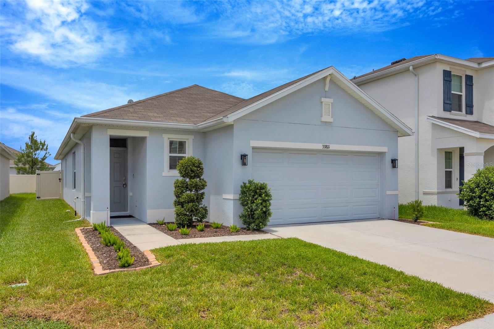 Welcome to this beautifully maintained newer home built in 2022, located in the desirable Wesley Chapel area! This spacious 3-bedroom, 2-bath residence offers a modern open-concept layout perfect for comfortable living and entertaining. The well-appointed kitchen features stainless steel appliances, contemporary finishes, ample cabinet space, and flows seamlessly into the living and dining areas. The primary suite includes a private en-suite bathroom with dual sinks and generous closet space, while two additional bedrooms provide flexibility for family, guests, or a home office. A washer and dryer are included for added convenience. Enjoy Florida living year-round on the covered lanai overlooking a fully fenced backyard—ideal for relaxing or outdoor gatherings. Additional highlights include a 2-car garage and newer construction for energy efficiency. Conveniently located near shopping, dining, schools, and major roadways, this move-in ready home is located in one of Wesley Chapel’s growing communities.
