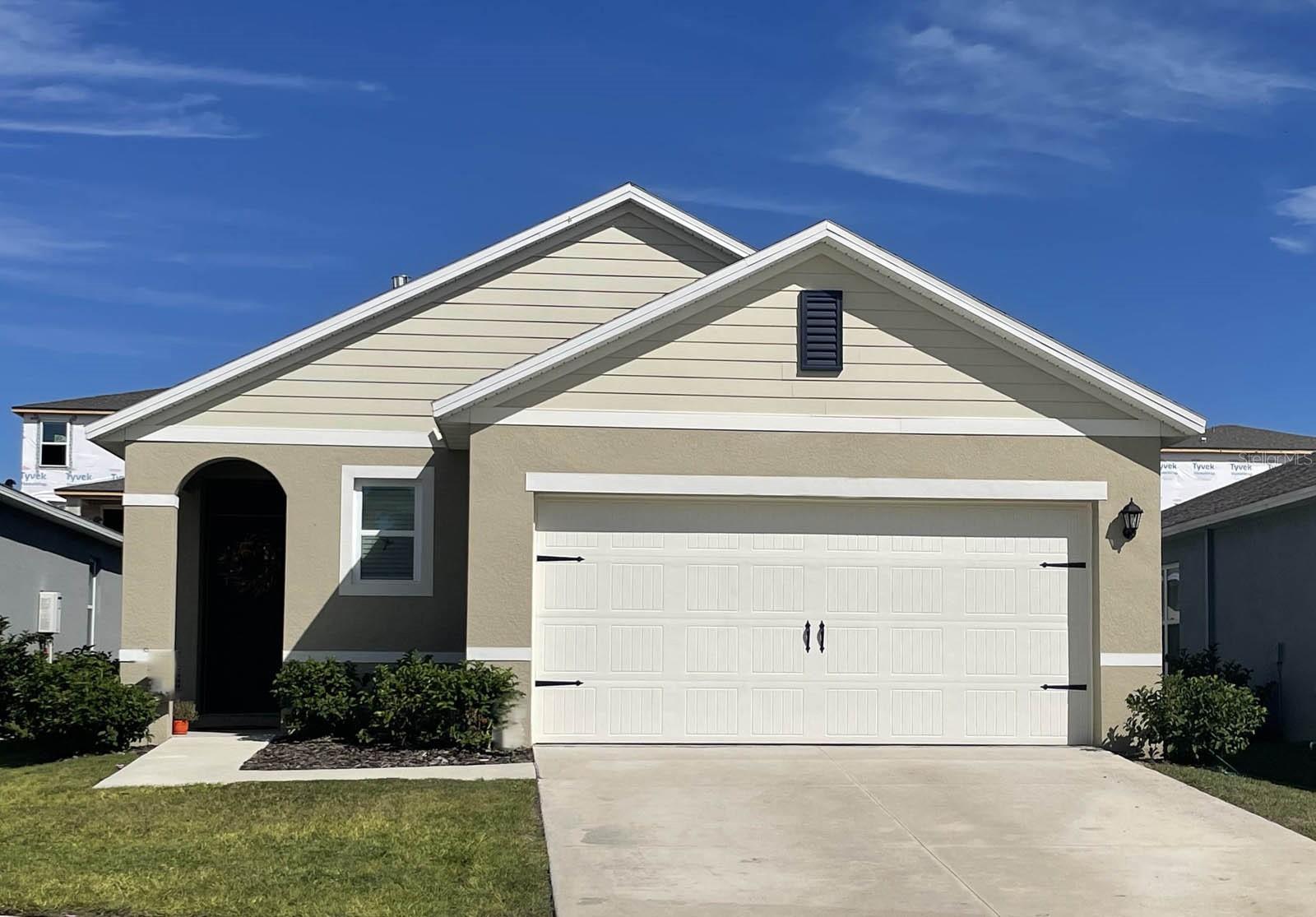 Under Construction. The Allex is one of our one-story floorplans featured in our Cascades in Davenport, Florida. With 2 exteriors to choose from, the Allex is sure to turn heads.

Inside this 3-bedroom, 2-bathroom home, you’ll find 1,504 square feet of comfortable living. The living area is an open concept, where your kitchen, living, and dining areas blend seamlessly into a space perfect for everyday living and entertaining. Relax on the covered lanai looking out to your backyard.

The kitchen features quartz countertops, stainless-steel appliances and a walk-in pantry which are sure to both turn heads and make meal prep easy. You’ll never be too far from the action with the living and dining area right there.

In every bedroom you’ll have carpeted floors and a closet in each room. Whether these rooms become bedrooms, office spaces, or other bonus rooms, there is sure to be comfort.

The primary bedroom located in the rear of the home has its own attached bathroom that features a walk-in closet and all the space you need to get ready in the morning. Sharing a sink isn’t a worry with the double vanity.

Like all homes in Cascades, the Allex includes all concrete block and also smart home technology, which allows you to control your home anytime with your smart device while near or away.

Contact us today and find your home at Cascades.

*Photos are of similar model but not that of the exact house. Pictures, photographs, colors, features, and sizes are for illustration purposes only and will vary from the homes as built. Home and community information including pricing, included features, terms, availability, and amenities are subject to change and prior sale at any time without notice or obligation. Please note that no representations or warranties are made regarding school districts or school assignments; you should conduct your own investigation regarding current and future schools and school boundaries.*