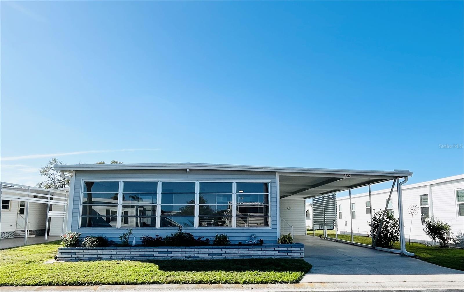 Welcome to this well maintained turnkey furnished home located in the ONLY Resident Owned Park in the City limits of Sarasota!! This 2 bed 2 bath 1,056sf home is positioned close to the clubhouse and both access gates. The comfortably furnished large living room is just off the kitchen and dining and has sliders that lead to the 220 sf Florida room. The kitchen is a wide galley with a breakfast counter space, pantry and storage closet. The dining room has a built in server giving plenty of additional storage. The primary suite has a king bed set, extra large walk in closet and remodeled bath with a step in shower. The guest bedroom is outfitted with a queen bed set. The full guest bath has a tub/shower and high profile stool. The Florida room has a newer insulated roof, wall to wall windows that overlook the greenbelt ( no mobile home directly across ) and exterior access door, carpet installed 2019 and a newer ceiling fan/light. The shed houses the washer/dryer water heater, utility sink plus plenty of space for additional storage. 

Updates include: Galv Metal Roof Over to main home 2019, Florida Room Insulated Roof Over 2021, Carport has reinforced braces, HVAC 2013, Luxury Vinyl plank flooring 2020, carpeting 2009 & 2019, subfloors replaced throughout with plywood, some windows updated, water heater 40 gal 2023 in shed, interior breaker box 2022, vapor barrier 2013, sewer line PVC, plumbing lines 2012. Hurricane shutters give added protection to the East and South windows. 

The gated 90 acre community boasts a low maintenance fee with its vast amenities, starting with the spacious Clubhouse outfitted with a full commercial cook kitchen, event stage, audio/visual, dance floor, state of the art fitness room, activities hall, library with books/movies/puzzles and a pool table. Outside recreation includes an extra large heated pool with a handicap ramp, a spacious kidney shaped hot tub, ample umbrella tables and lounge chairs and updated shower rooms. Oak trees shade the beautiful park area, picnic tables and a community grill. Additional amenities to enjoy are the community putt putt course, bocce ball, ping pong and corn hole. Oakwood Manor is a vibrant community with numerous social events and activities. It is conveniently located adjacent to Legacy Trail and 12 newer pickle ball courts. Just a short drive to our crystal sand beaches, downtown area, the marina, fishing pier, local golf courses, shopping, variety of restaurants, the museum, SRQ airport, SMH and Doctors hospitals. Please note that Oakwood is a 55+, no pet, no motorcycle Park.