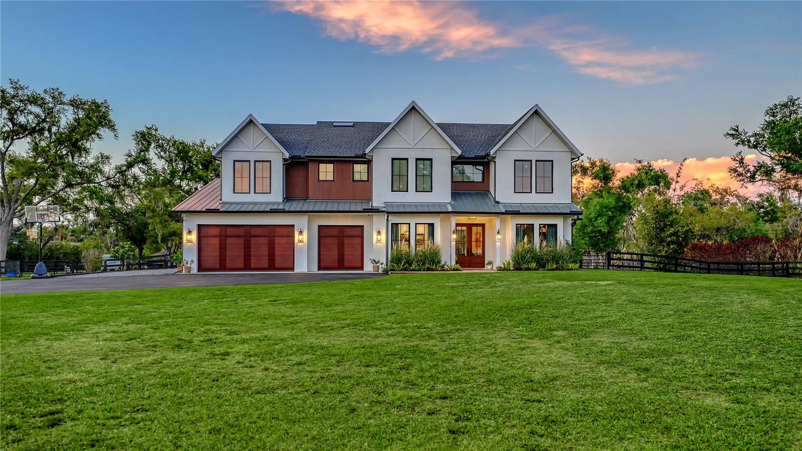 This private Saddle Creek custom estate is more than a home. It’s a place where design, nature, and lifestyle come together in a way that simply feels extraordinary. 

Set behind a long private drive and surrounded by over 5.5 acres of peaceful countryside, the property offers a rare blend of refined design, modern comfort, and wide-open Florida living.

From the moment you arrive, the home’s striking architecture sets the tone: crisp white exterior, warm wood accents, and a welcoming front porch framed by lush landscaping.

Inside, the home unfolds with light-filled spaces and soaring ceilings, where oversized windows frame endless views of the surrounding landscape. Rich wood flooring, detailed millwork, and thoughtfully curated finishes create an atmosphere that feels both elegant and inviting.

The great room is truly breathtaking with dramatic two-story ceilings, expansive picture windows, and a beautiful fireplace that anchors the space while natural light pours in from every angle. 

The open-concept design flows effortlessly into the chef’s kitchen, where custom cabinetry, stone countertops, high-end appliances including a built-in Miele coffee machine, and a large center island create a space equally suited for everyday living and entertaining.

A stunning butler’s pantry and custom wine bar elevate the experience even further, offering beautiful storage and the perfect setting for hosting gatherings with family and friends.

The primary suite is a peaceful retreat, complete with generous proportions, soft natural light, and a spa-inspired bathroom designed for relaxation. With five additional bedrooms and ample bathrooms, there is plenty of space for family, guests, or flexible use such as a home office or fitness room.

The expansive covered lanai features a beautifully finished ceiling with exposed wood beams, ceiling fans, and multiple seating areas. The sparkling pool is surrounded by elegant stone decking and ample space for lounging under the Florida sun. A custom outdoor pizza oven and grilling area create the ultimate setting for al fresco dining.

Beyond the patio, the property opens to a vast, park-like lawn, offering exceptional privacy and a serene natural backdrop. With this much space, there is room to create your own private retreat, whether that includes recreational amenities, a garden, a fire pit, or space for horses and other animals. 

Despite its quiet setting, this property is conveniently located just 10 to 15 minutes from shopping, dining, hospitals, and I-75, with the world-renowned Siesta Key Beach and Sarasota’s newest shopping destinations only about 30 minutes away. 

From sunrise over open acreage to evenings by the pool and fire pit, this home offers a lifestyle that feels both effortless and unforgettable. Experience it for yourself. Schedule your private showing today!