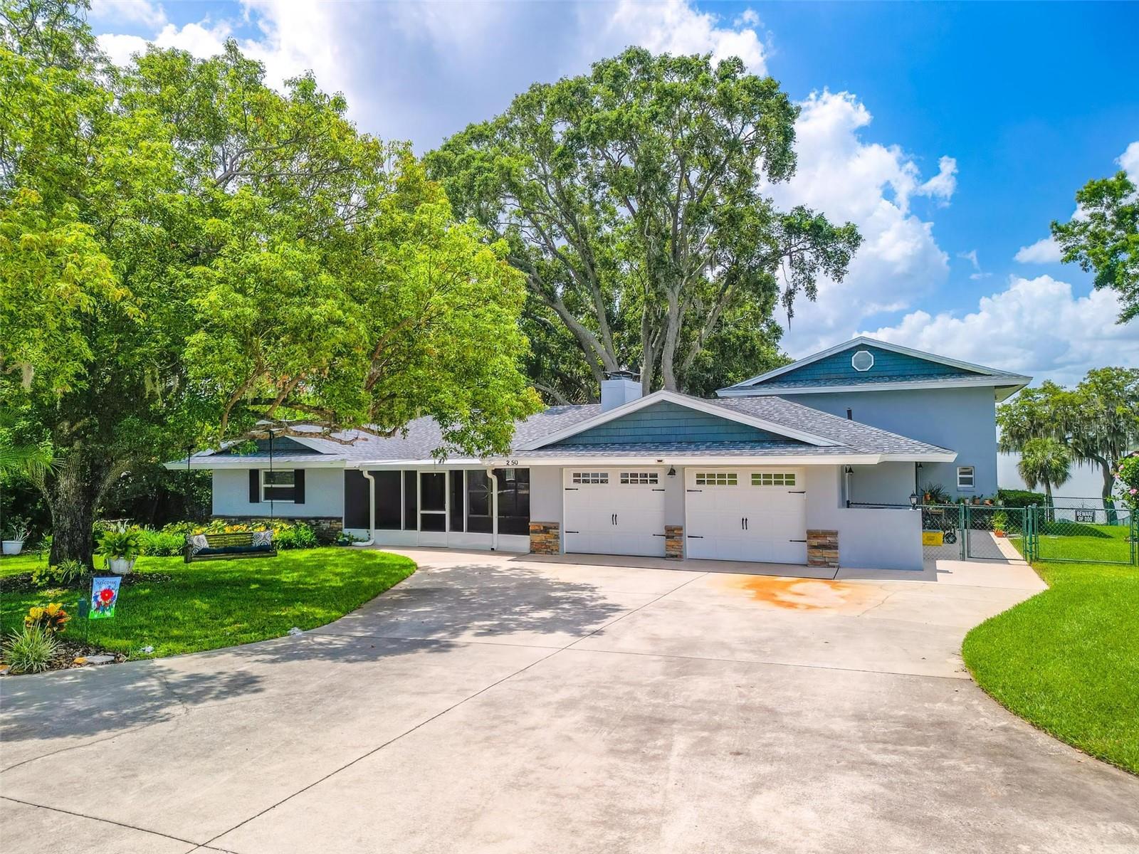 Prepare to be captivated by this beautifully updated lakefront estate on Lake Hartridge, perfectly positioned along the highly sought-after Winter Haven Chain of Lakes. Situated on approximately 1.3 acres with an impressive 115 feet of waterfront, this exceptional property offers a rare combination of luxury, privacy, and breathtaking panoramic water views, all tucked away on a peaceful dead-end street. Mature oak trees and lush tropical landscaping create a timeless Old Florida ambiance while blending seamlessly with the home’s fresh, modern updates.

A long private driveway welcomes you to the property, leading to an oversized detached two-car garage complete with a private apartment above—ideal for guests, multigenerational living, rental income, or a secluded home office—and a convenient full bathroom below.

Inside the main residence, an expansive and thoughtfully designed floor plan features four spacious bedrooms and 4.5 beautifully appointed bathrooms. One bedroom is currently styled as a cozy movie room, creating the perfect entertainment space for relaxing evenings or family gatherings. The luxurious first-floor primary suite serves as a true retreat, offering a spacious sitting area with stunning views overlooking the sparkling screened pool and tranquil lakefront setting. The spa-inspired primary bathroom showcases a soaking tub, oversized walk-in shower, elegant dual vanities, and generous space designed for comfort and relaxation.

At the center of the home is the beautifully updated gourmet kitchen, featuring sleek quartz countertops, modern cabinetry, stainless steel appliances, and abundant prep and storage space sure to impress any chef. Elegant porcelain flooring flows throughout the main living areas, while plush carpeting adds warmth and comfort to the bedrooms. Recent upgrades, including a new roof and new AC system, provide peace of mind and enhance the home’s fresh, move-in-ready appeal.

Designed to maximize the spectacular lake views, the expansive lanai and private screened-in pool area with an in-ground hot tub create the ultimate outdoor oasis for year-round Florida living. Newly refreshed pool and lanai screening further elevate the experience, seamlessly blending indoor and outdoor entertaining spaces.

For boating enthusiasts, the property truly stands out with a private covered dock featuring a metal roof and boat lift, offering direct access to the renowned Winter Haven Chain of Lakes, known for boating, fishing, watersports, and unforgettable sunset cruises.

Additional highlights include dedicated RV parking with electrical, water, and sewer hookups, making this property ideal for those seeking adventure without sacrificing luxury and convenience.

Located in the heart of Winter Haven, known as the “Chain of Lakes City,” residents enjoy easy access to over 50 interconnected lakes, waterfront dining, boutique shopping, recreational trails, and convenient access to both Tampa and Orlando attractions.

This extraordinary lakefront estate perfectly combines modern updates, timeless elegance, and resort-style living—offering a truly rare opportunity to own a one-of-a-kind waterfront retreat.