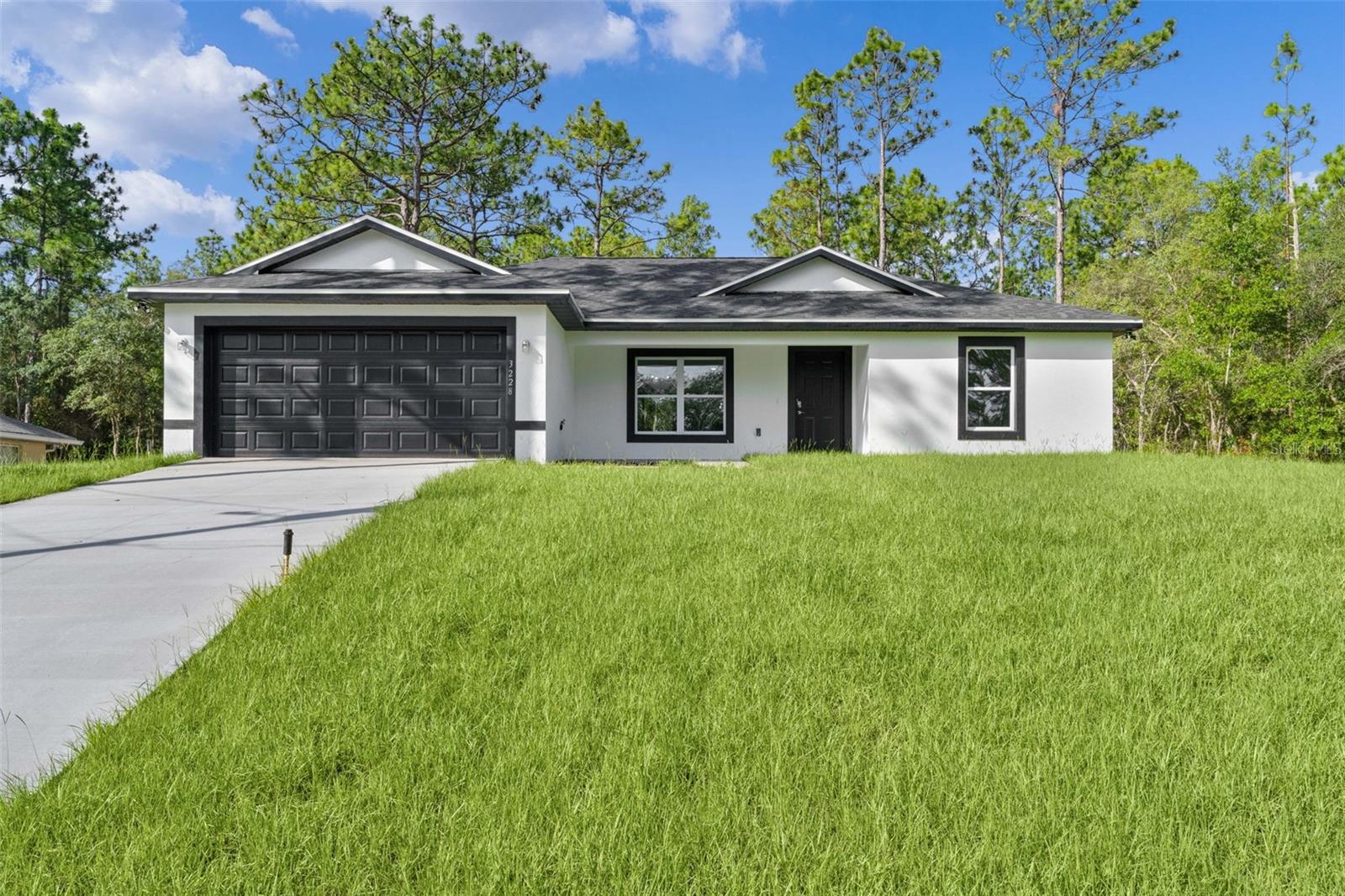 BRAND NEW CONSTRUCTION | MOVE-IN READY!

Welcome to this beautifully crafted 3-bedroom, 2-bathroom home located in the growing community of Citrus Springs, where you'll enjoy NO HOA and NO CDD fees. Situated on a generous 0.31-acre lot, this property offers additional privacy, outdoor space, and a desirable elevated homesite that sits higher than the street, enhancing curb appeal and drainage.

Designed with both style and functionality in mind, the home features a spacious open-concept floor plan with waterproof luxury vinyl plank (LVP) flooring throughout. The modern kitchen is the heart of the home, showcasing quartz countertops, 42-inch shaker cabinets, stainless steel appliances, and a large center island with breakfast bar seating, perfect for entertaining or everyday living.

The thoughtfully designed split-bedroom layout provides privacy for the primary suite, which includes a walk-in closet and a beautifully appointed ensuite bathroom with dual vanities and a tiled walk-in shower.

Enjoy Florida living year-round from the oversized covered lanai, ideal for relaxing, grilling, or hosting guests. Additional highlights include a welcoming front porch and a location on a quiet, established street surrounded by completed homes, just minutes from schools, parks, shopping, and the Citrus Springs Community Center.

Don't miss this opportunity to own a brand-new, move-in-ready home in one of Citrus County's fastest-growing communities. Schedule your private showing today!

Some photos have been virtually staged for illustrative purposes. Furniture, décor, and other virtual enhancements are not included in the sale.