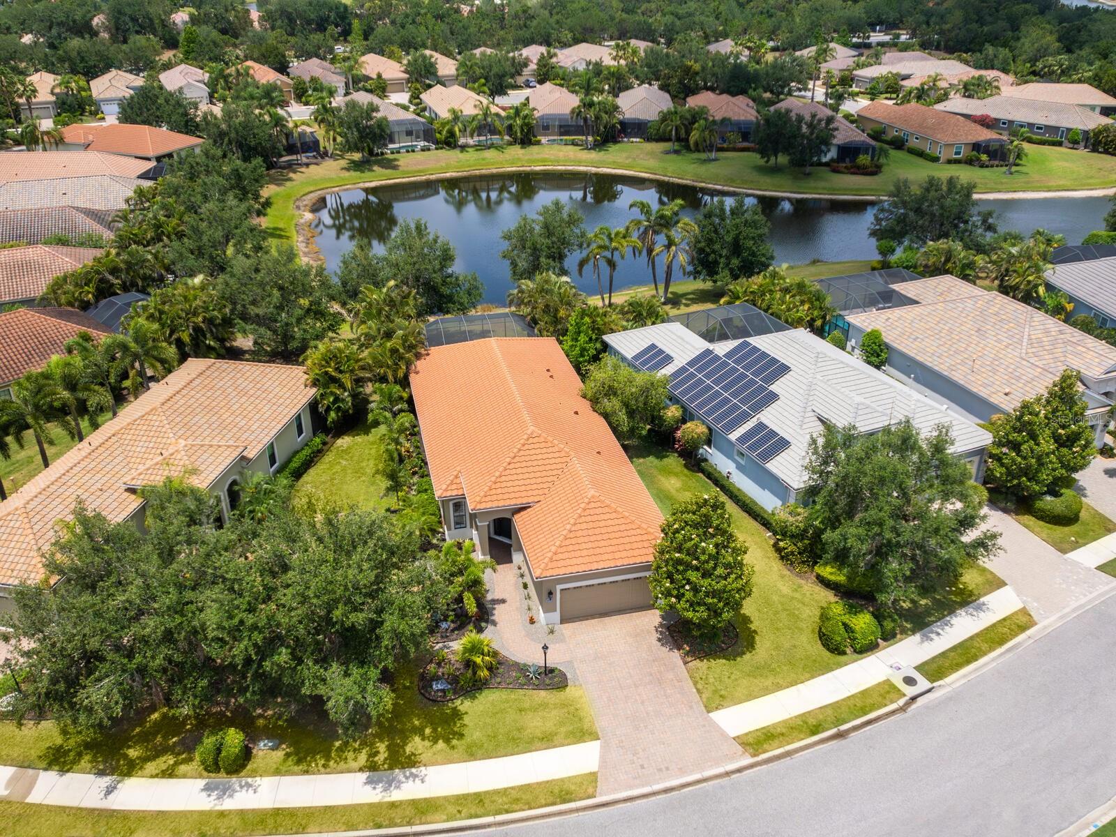 This beautifully updated and meticulously maintained home is in the sought-after Belleisle neighborhood within Country Club East. This designer-appointed residence features two bedrooms, two baths plus a stunning home office with built-in cabinetry and double French doors. The open-concept layout is elevated by high-end upgrades throughout, including custom cabinetry, designer lighting, luxury flooring, plantation shutters and refreshed front landscaping. Enjoy year-round indoor-outdoor living with a private screened lanai, pool, and tranquil lake views that create a peaceful backdrop for entertaining or relaxing. The chef’s kitchen is equipped with granite countertops, stainless steel appliances and a natural gas range, while the spacious primary suite offers dual vanities, a walk-in shower and large walk-in closet. A newly added mini-split air-conditioning system in the garage adds versatility to the space. Belleisle is maintenance-free, offers its community pool and is part of the amenity-rich, gated community of Country Club East, which includes three resort-style pools, fitness facilities, a clubhouse, park areas and recreational trails. Optional memberships are available at Lakewood Ranch Golf & Country Club, granting access to The Lodge, three championship golf courses, tennis and pickleball courts, fine dining and exclusive social events. Ideally just minutes from Waterside Place, UTC and everything Lakewood Ranch has to offer, this exceptional property is a blend of luxury, comfort and lifestyle.