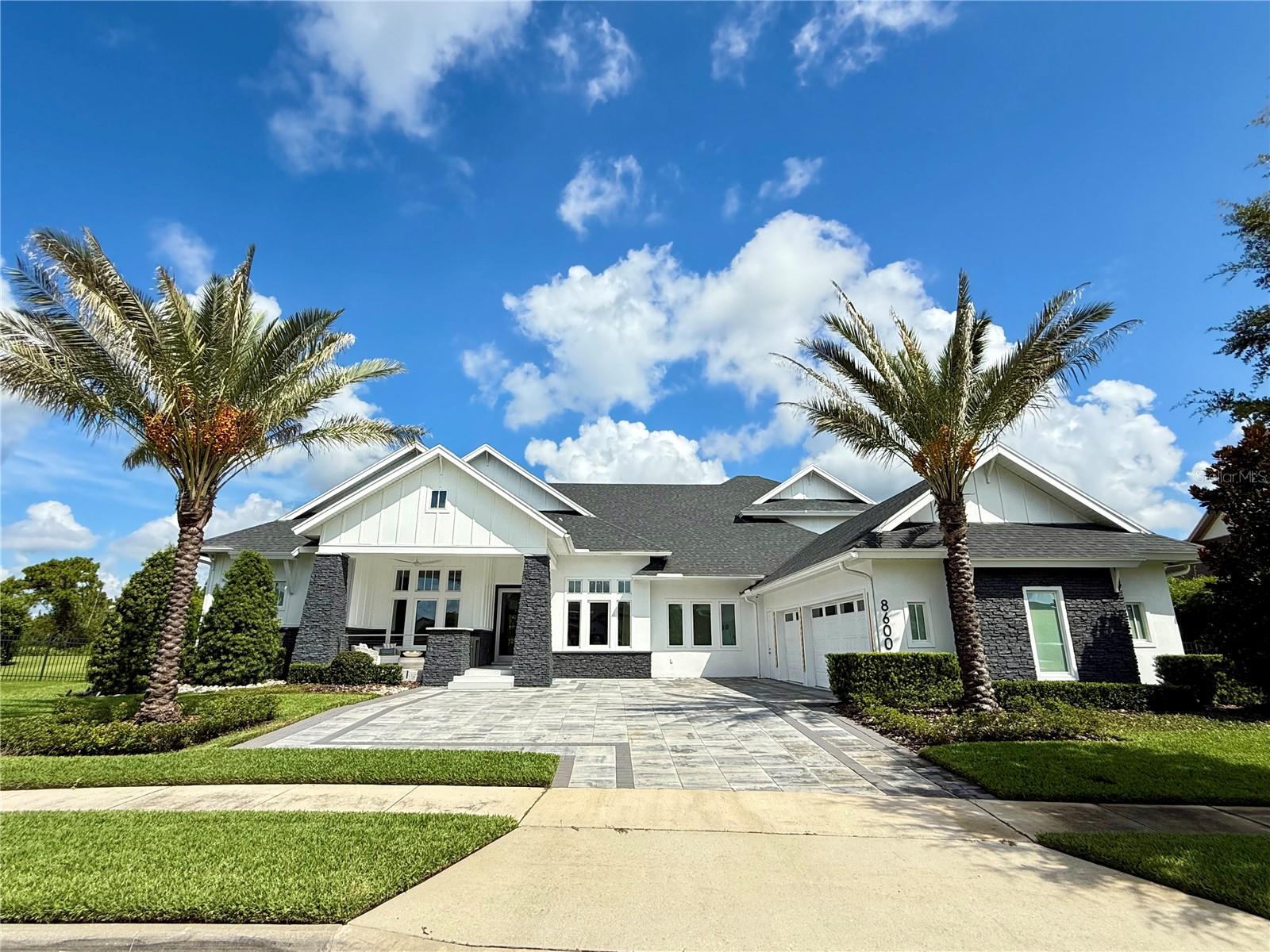 Auction Property. Luxury Live Auction! Bidding to start from $2,499,000.00!   Experience Luxury Living at Its Finest.
This warm, contemporary residence blends modern-transitional style with the highest level of finishes throughout. Offering approximately 5,718 sq. ft. of living space and nearly 7,594 sq. ft. under roof, every detail of this home is crafted to deliver elegance, functionality, and lifestyle excellence.

Featuring five spacious ensuite bedrooms plus an additional full bathroom, the layout is both versatile and inviting. On the main level, you'll find four bedrooms, including the luxurious primary suite a serene retreat with two oversized walk-in closets and a spa style bathroom adorned with exquisite finishes. Additional main-level spaces include formal living and dining rooms, an open-concept kitchen-family room-eating area, a Florida room, a spacious laundry room, a dedicated home office, and a three-car garage with ample storage. Upstairs offers one more bedroom and a versatile multi-purpose room, all set on a .71-acre lot.

At the heart of the home, the gourmet kitchen showcases frameless contemporary cabinetry with automatic lighting, a generous center prep island, three built-in pantry cabinets and premium Wolf and Sub-Zero appliances. The kitchen flows seamlessly into the spacious great room and Florida room, creating the perfect indoor-outdoor living experience.

Step outside to your private outdoor oasis, where beautifully landscaped grounds frame serene conservation views. Enjoy a sparkling pool, relaxing spa, summer kitchen with Bull premium appliances, tranquil yard, expansive covered living space, a fireplace and a basketball court. With plenty of outdoor seating areas, this space is designed for year-round entertaining.

This exceptional home combines sophisticated design, luxurious finishes and an unbeatable layout perfect for both everyday living and memorable gatherings.