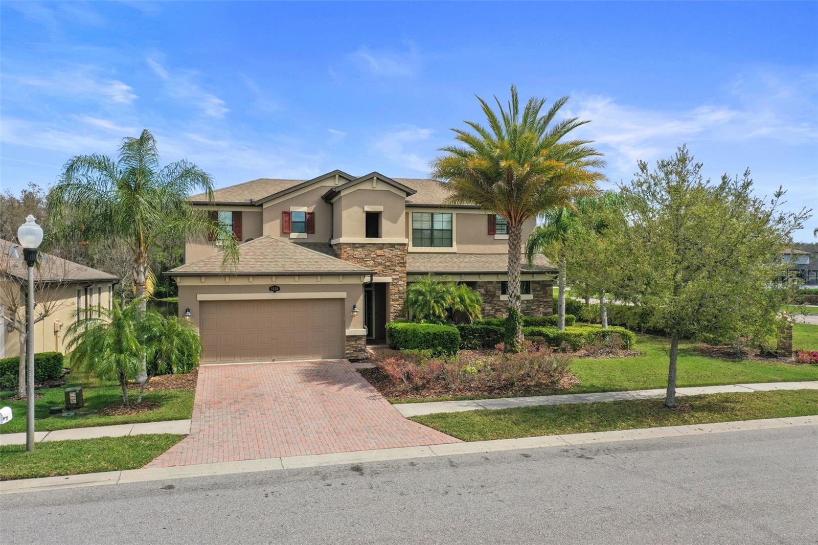 Welcome to 1670 Cameron Court, located within The Sanctuary at Trinity Preserve, a gated community in the heart of Trinity. This executive-style POOL-Home provides a rare opportunity to enjoy a corner lot with conservation/pond views, NO Flood Zone/NO CDD and features 4 bedrooms, 3.5 bathrooms, a private office, loft room & nearly 3,000 sq ft of thoughtfully designed living space. Originally built as the M/I Homes model residence for the community, this exceptional home showcases numerous builder upgrades, designer finishes, enhanced architectural details and an extended 31 x 11-foot lanai designed to maximize Florida’s indoor-outdoor lifestyle. Upon entering, you are greeted by a dramatic two-story foyer that creates an impressive sense of space and natural light. The open-concept floor plan flows effortlessly into the spacious great room, where decorative wood beam tray ceilings, custom wall detailing, hardwood plank flooring, plantation shutters, custom draperies, 5 ¼” base boards and expansive views of both the pool & pond creating a warm & inviting atmosphere. At the heart of the home is a chef-inspired kitchen featuring granite countertops, oversized center island with breakfast seating, 42” walnut cabinetry, tile backsplash, pantry, stainless steel appliances, built-in microwave, double wall ovens, abundant storage, adjacent dining area, all providing a fabulous workable space for both entertaining and everyday living. The first-floor primary suite serves as a private retreat overlooking the pool with conservation/water views. Elegant finishes include 10' ft tray ceilings, 5 ¼” crown molding, chair rail accents, a spacious walk-in closet, dual granite vanities, a garden tub, and a walk-in shower with rain shower head. Upstairs, a versatile loft with built-in bookcase shelving provides additional living space ideal for a media or study area. The second level also includes a junior suite with a private en-suite tub/shower bath, two additional bedrooms with walk-in closets and a shared dual-sink bathroom. Additional features include all TV's & Wall mounts, dedicated office conveniently located by front entrance, wired security system, large laundry room with 42” upper cabinetry, drop zone area, under-stair storage and a tandem garage with space for up to three vehicles & EV charging capability. Designed for year-round Florida living, the extended covered lanai overlooks a screened, heated pool and spa framed by an expansive brick paver deck & provides an opportunity for multiple outdoor living spaces with ample room for an outdoor kitchen area. Whether entertaining guests or enjoying a peaceful evening, the tranquil pond & conservation views offer an exceptional setting to relax and unwind. Residents of Trinity Preserve enjoy a gated entrance, NO CDD, LOW HOA fees & convenient access to State Road 54, Gunn Highway, the Suncoast Parkway, Jay B. Starkey Wilderness area, shopping, dining, entertainment, medical facilities and ideally situated near some of Trinity's most sought-after schools. 1670 Cameron Ct offers the rare combination of both a model-pool home on a premium conservation/pond homesite, what a great opportunity to enjoy all that Florida has to offer!