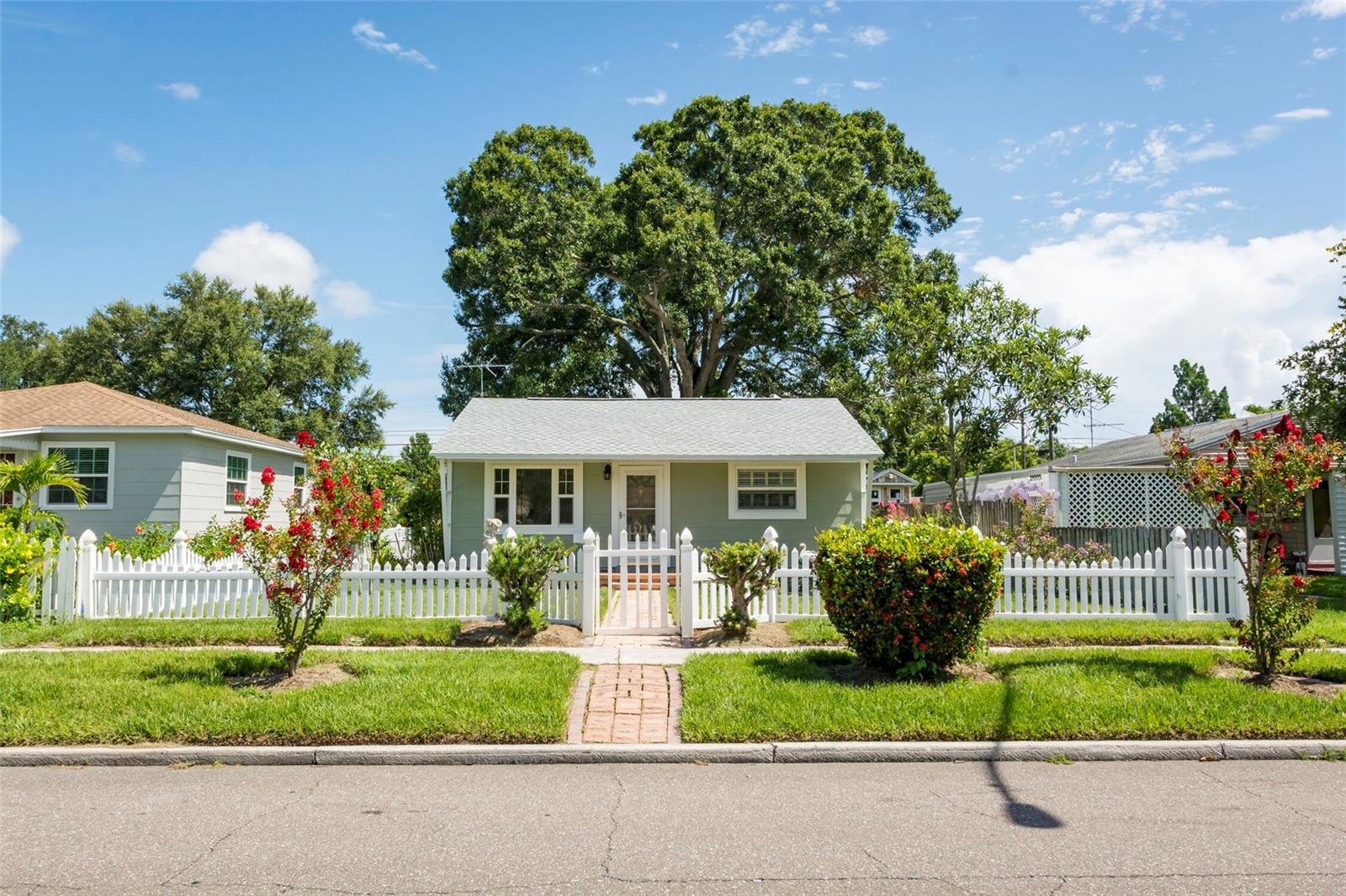 Welcome to this beautifully maintained home where timeless charm meets modern updates. Filled with natural light, the interior features rich wood floors, custom millwork, plantation shutters, and newer impact-rated, energy-efficient windows (2023). Fresh interior and exterior paint (2023), a well-maintained HVAC system (2016), and a five-year-old roof provide comfort and peace of mind. The updated landscaping and private backyard create the perfect setting for relaxing or entertaining, complete with a paver walkway, fire pit, detached workshop, and rear alley access with a private carport. Inside, the flexible floor plan offers endless possibilities for a home office, guest room, or creative space. The eat-in kitchen features a gas range, solid-surface countertops, and stone backsplash, while the oversized laundry room provides exceptional storage and workspace. Ideally located less than two miles from Trader Joe’s and Whole Foods, and just minutes from vibrant Downtown St. Petersburg, this move-in-ready home offers the perfect blend of character, convenience, and lifestyle.