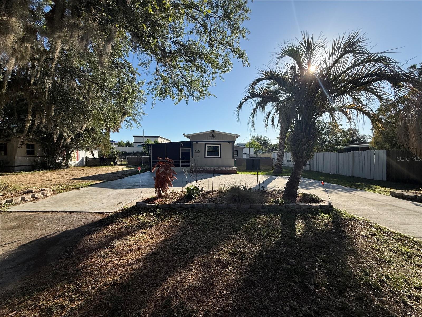 Come see this 3 bedroom 2 bath mobile home.  No HOA and no Bond.  Close to the Villages and Spanish Springs Town Square.  Two bedrooms and bath in the main living area and then you have a private place for your guests in the attached bonus bedroom and bath for your privacy, off the enclosed side porch.  Inside laundry and covered back patio.  The private and fenced yard allows your pets to roam freely along with a full-sized shed for storage.  The new double concrete driveway allows up to 4+ cars for parking.  New washer and dryer 2024, main bath remodeled 2022, HVAC 2017, New Septic tank and drain field April 2026.