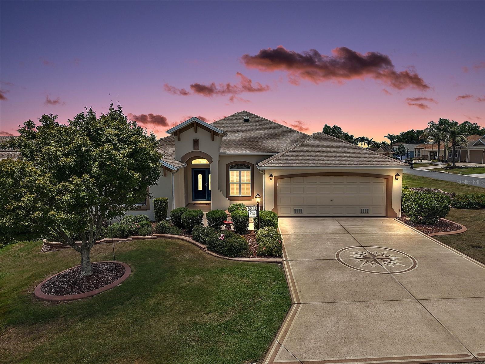 Welcome to this INCREDIBLE, BLOCK and STUCCO, 3/2 Designer Gardenia with FRONT PAVER PATIO and SPACIOUS, UNDER-AIR, GLASS-ENCLOSED LANAI perfectly situated on a LARGE CORNER LOT with ROOM FOR A POOL in the highly sought-after Village of Amelia - JUST MINUTES to Lake Sumter Landing with live nightly entertainment! BOND PAID! ROOF (2023), HVAC (2025), HWH (2021). Adding to the exterior charm of this FABULOUS home are TIERED landscaping and DECORATIVELY PAINTED drive and walkways. Step through a LEADED-GLASS entry into the GENEROUS foyer boasting HIGH ceilings and TILE flooring. UPGRADES THROUGHOUT include PLANTATION SHUTTERS, MODERN LIGHTING and FANS, and FOUR SOLAR TUBES that flood the home with an ABUNDANCE of NATURAL LIGHT! The EXPANSIVE kitchen showcases GORGEOUS, STAGGERED CHERRY cabinetry with a corner accent shelf, GRANITE countertops, STAINLESS appliances, INDUCTION range, TILE backsplash, built-in PANTRY, ROLL-OUT SHELVING, and an EAT-IN breakfast bar. The adjoining dinette features DOUBLE windows with an arched transom and decorative sunburst accent. Soaring VAULTED ceilings and an OPEN-CONCEPT floor plan create a SPACIOUS and AIRY main living area ideal for both everyday living and entertaining. The formal dining room is accented by ELEGANT columns, adding architectural charm and sophistication. Four-panel sliding glass doors open to the EXPANSIVE 28'x9’, UNDER-AIR, GLASS-ENCLOSED LANAI, providing approximately 252 square feet of additional year-round living space. This inviting retreat features DECORATIVELY PAINTED tile-pattern flooring, SOLAR shades, TWO ceiling fans, and PRIVACY landscaping that creates a bright yet secluded setting while an exterior glass door leads to a SIDE PATIO with stairs, offering the perfect space for grilling! Back inside, retreat to the primary suite boasting a VAULTED ceiling, WOOD-PLANK TILE flooring, and TWO SPACIOUS WALK-IN closets. Its ensuite bathroom features DUAL CHERRY vanities with GRANITE tops, TILED ROMAN-STYLE WALK-IN shower, LINEN closet, and a separate water closet. A SPLIT FLOOR PLAN places two additional bedrooms and second bathroom behind a POCKET DOOR near the front of the house, creating a PRIVATE guest wing and/or quiet home office. Both bedrooms offer TRAY ceilings, WOOD-PLANK TILE flooring, LARGE windows, and built-in closets. 
The second bathroom features a CHERRY vanity with GRANITE top, TILED tub and shower combination, and a hall LINEN closet. An INTERIOR LAUNDRY ROOM showcases CHERRY cabinetry, hanging rod, and built-in UTILITY SINK. It leads you into the 528sf TWO-CAR GARAGE with PAINTED floor, attic access with stairs, a Kinetic water softening system, and PLENTY of room for parking and storage! DON’T MISS YOUR OPPORTUNITY to make this WONDERFUL HOME YOUR OWN! The Village of Amelia is ONLY MINUTES from Lake Sumter Landing - where you’ll find an array of shopping, dining, and live nightly entertainment! You’ll also be close to Mallory Hill and Arnold Palmer Country Clubs and Championship Golf Courses; Health enthusiasts will love the proximity to the Lake Miona Regional Recreation Center and Fitness Trail; Also nearby are Amelia, Mallory Square, Caroline, and Coconut Cove Pools and Recreation Centers; and conveniently located “between the 6’s” with an abundance of shopping, dining, banking, medical, and more! PLEASE WATCH OUR WALKTHROUGH VIDEO of this FANTASTIC HOME in an AMAZING LOCATION and call today to schedule your Private Showing or Virtual Tour!