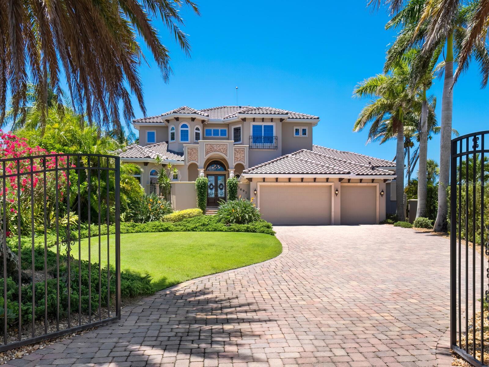Exceptional waterfront property offering the best of everything - spectacular views of Sarasota Bay from almost every room. Located on a quiet cul-de-sac in a convenient mainland community. Southern exposure affords beautiful waterfront views both day and night. Dolphin and other sea life play at the deepwater dock (2018) with power lifts for boats and jet skis. An expansive paver deck with fire-pit surrounds the solar heated waterfront salt water pool and spa. A gated courtyard leads to the entry of this custom-built home which features volume ceilings, wood and tile floors, custom millwork & crown molding. This welcoming home is all about the Sarasota waterfront lifestyle. The centrally located island kitchen with granite countertops, wood cabinetry, full pantry, 132 bottle Subzero wine fridge, massive storage and workspaces flows to the family room. Pocketed glass sliders lead to the huge covered and screened lanai - perfect for relaxing and outdoor dining. A generous first-floor master suite with full bay views. Large executive office with a private entrance. Upstairs, a bonus room is flanked by three bedrooms and two baths, all with access to a bayfront terrace and rooftop deck with panoramic views of the bay and the mainland.  Three-car garage with epoxy floor. Easy access to downtown Sarasota, Siesta Beach, shopping and Pine View School. Upgraded home security system, home audio system and new well pump.NEW ROOF 2021, NEW SEAWALL & DOCK 2018 (JET SKI LIFT 4000 lbs, BOAT LIFT 12000 lbs). NEW EXTERIOR PAINT 2023. NEW SPA HEATER 2023.