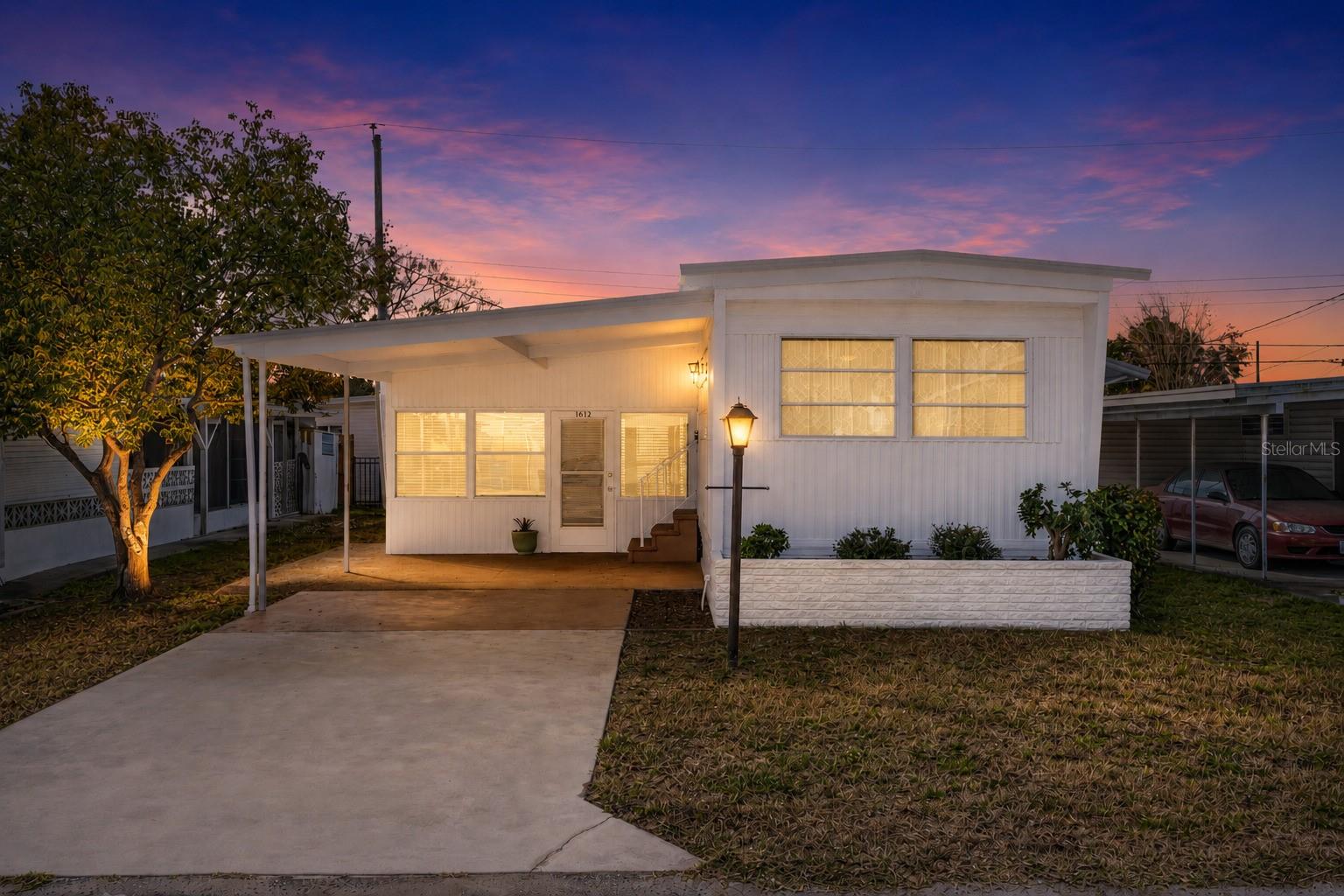 One or more photo(s) has been virtually staged. NEW PRICE! Welcome to 1012 50th Ave Plz West! Excellent opportunity to purchase this beautifully maintained, 2 bedroom / 1.5 bathroom home in a community with NO HOA, NO age restrictions, and land ownership - no lot rent! This mortgagable manufactured home features a conveniently split floor-plan and has newer light fixtures, creating a clean, updated feel throughout. Brand new luxury laminate flooring enhances the bright living space, while the functional kitchen and spacious layout provide everyday comfort. Bedroom 1 offers two closet spaces for ample storage. Bedroom 2 includes a closet/utility area with an attached half bath, adding flexibility and convenience. Ideally located near popular restaurants, beautiful Gulf beaches, and Sarasota International Airport, this home would be perfect as a primary residence, snowbird getaway, or investment opportunity!