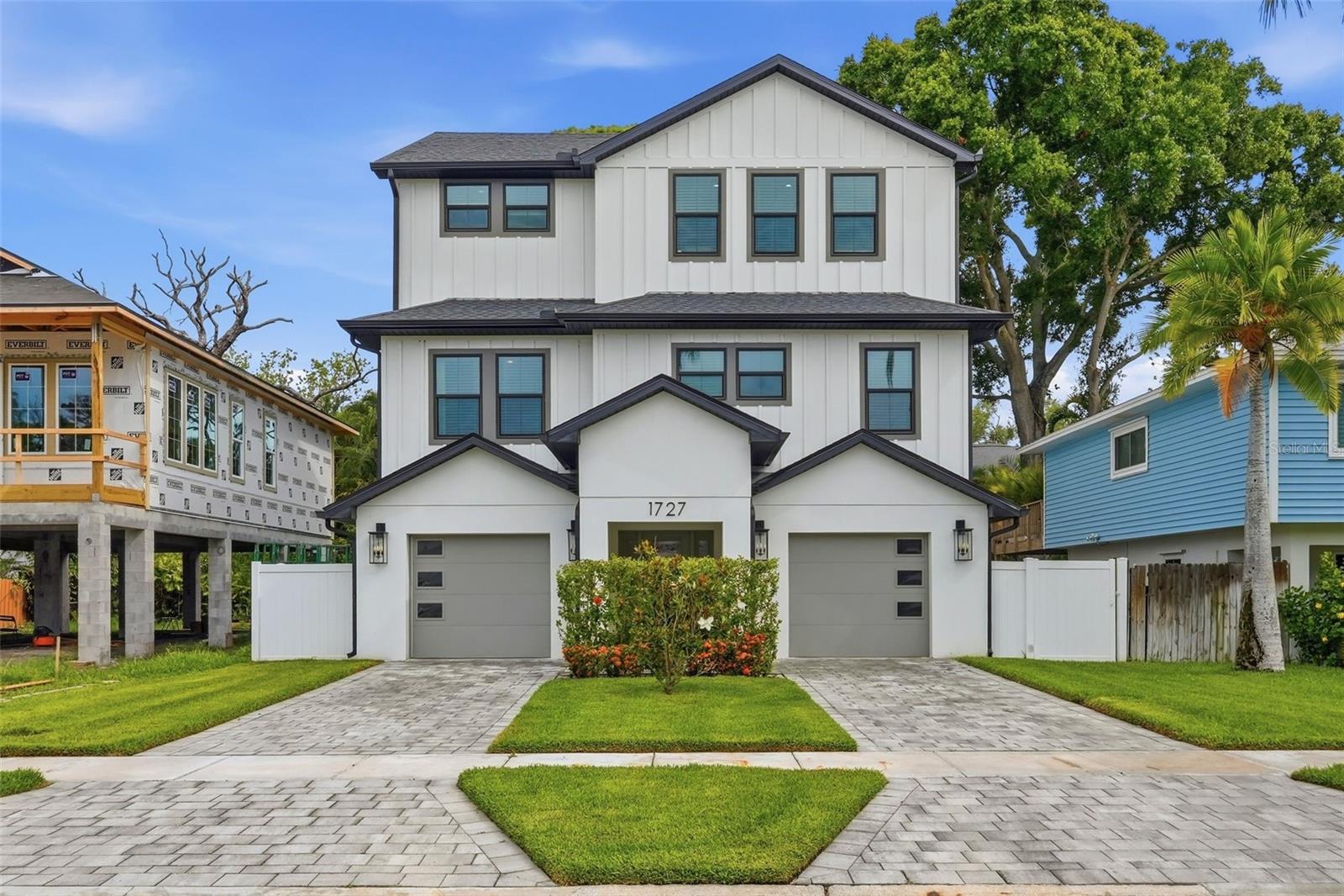 Step into the perfect blend of modern luxury and total coastal peace of mind in this stunning 5-bedroom, 3-bathroom residence. Built in 2022, this home offers the rare opportunity to own nearly-new construction in a waterfront community—a neighborhood where you can feel the energy of growth and the pull of the bay at every turn. The first thing you’ll notice is the thoughtful, elevated design. In a coastal town, this architecture is the ultimate flex, offering a striking silhouette and the security of hurricane-impact-rated windows and doors throughout. Inside, the expansive layout effortlessly accommodates everything from a busy home office to hosting a full house for Sunday brunch without ever feeling crowded. The finishes are crisp and contemporary, but the practical upgrades are what truly elevate the lifestyle here. The massive, oversized garage is a dream for the hobbyist or adventurer; it features a dedicated EV charging station and ample flex space for a home gym, workshop, or storing all your waterfront toys like kayaks and paddleboards. Outside, the possibilities continue with a spacious backyard that’s ready to be transformed into your private oasis—yes, it’s perfectly sized to accommodate a pool. When you aren't relaxing at home, you’re just steps from lush neighborhood parks and minutes from the vibrant heart of downtown St. Pete. Enjoy world-class dining, boutique shopping, and the iconic pier, all while knowing you have a quiet, sophisticated sanctuary to return to. Why wait for a custom build when this massive, move-in-ready retreat is ready for you right now?