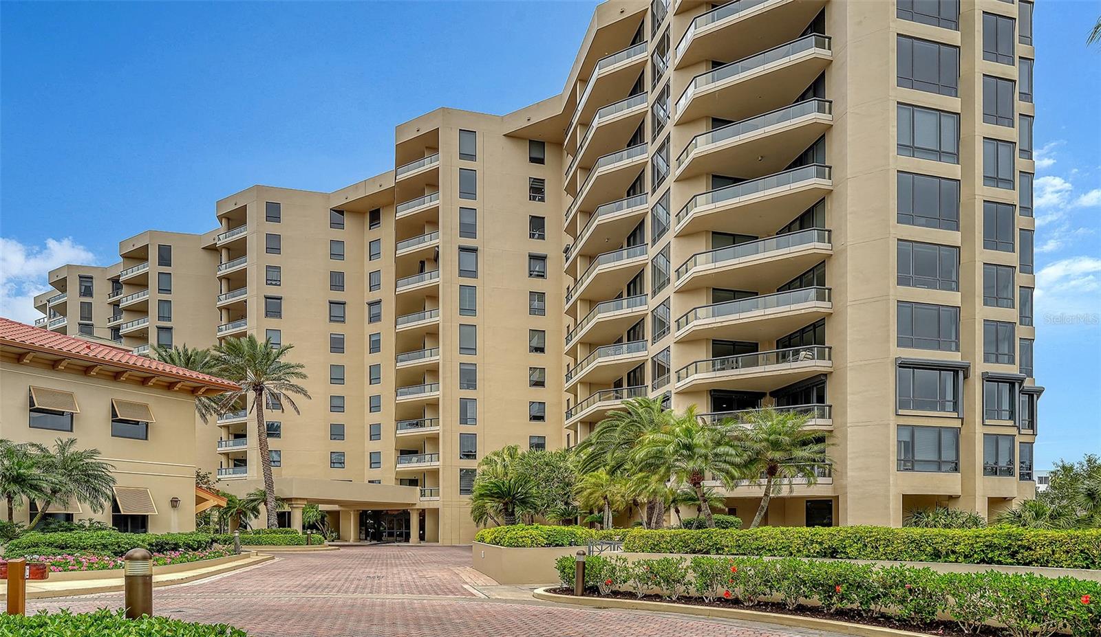 Welcome to a little piece of paradise on Longboat Key at the stunning gated Gulf-front condominium community of Water Club, which offers a coastal lifestyle complete with direct access to sandy beaches, high-end amenities and exceptional security and concierge services. This designer-inspired, two-bedroom, 2.5-bath condominium is on the newer north building's plaza level and features nearly 1,400 square feet, 10-foot ceilings, double crown molding, plank wood flooring in the living areas, natural colors and floor to ceiling storm impact windows and doors. An open floor plan offers garden views from the spacious living room and the kitchen, which has both a breakfast bar and a seating area. A beautiful kitchen renovation was completed in December 2025 with handsome wood cabinets, stone countertops and GE Profile appliances. The split plan allows privacy for owners and guests in the two separate primary en-suite bedrooms, each with large windows, custom drapes and carpet, wall closets with built-ins and baths with combination tub/showers. ?An expansive balcony with glass railing barriers can be accessed through the living area and one of the primary suites. This lovely condo conveniently has a stack washer and dryer, linen closet, underbuilding storage unit and assigned parking and its own front desk concierge. Behind the 24-hour guarded-gate is true luxury living with a modern clubhouse, state-of-the-art fitness room, locker room and spa, sauna, bar and lounge, library, game room, ballroom and catering kitchen and outside terrace for gatherings and watching sunsets over the Gulf waters. Besides the magnificent beach and Florida-friendly landscaped grounds, the outdoor amenities include a peaceful courtyard, fire pit, resort-style pool and hot tub and new Har-tru tennis courts. Water Club is conveniently near island golf courses and Publix, and a short distance from St. Armands Circle and downtown Sarasota for dining, shopping, entertainment and cultural venues.