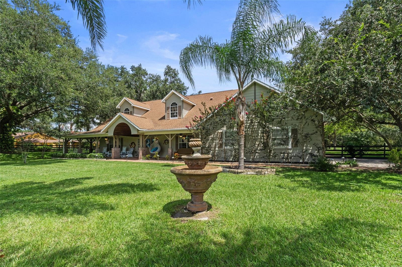Bring your horses and escape to your own private estate on nearly 2.5 beautifully fenced acres — where luxury, space, and flexibility come together just minutes from downtown Mount Dora.  Immaculately maintained, this home boasts a NEW roof (2025), NEW water heater, and NEW driveway and garage pads. 

This stunning 4-bedroom home was designed for both everyday comfort and unforgettable entertaining. From the moment you step inside, you’re greeted by soaring cathedral ceilings, rich real wood flooring, and an open, inviting layout filled with natural light. Upstairs, a spacious loft with two separate sitting areas creates the perfect space for a media room, game room, home library, or additional lounge areas.

Privacy and convenience abound, with three of the four bedrooms featuring their own en-suite bathrooms — ideal for guests or multi-generational living. Start your mornings on the charming covered front porch, where you can unwind and take in the peaceful surroundings of this quiet, upscale neighborhood.

Step outside and discover your personal Florida oasis. The expansive screened lanai features a heated pool and spa, surround sound system, outdoor TV viewing, and built-in cooling misters — creating the ultimate year-round entertainment space for hosting family and friends in comfort.

What truly sets this property apart is the incredible 50’ x 52’ barn/garage with RV-height clearance — an exceptionally rare feature with endless possibilities. Perfect for car collectors, RV owners, hobbyists, contractors, or business owners, this versatile space has even served as an income-producing workshop in the past. Attached is a climate-controlled 12’ x 36’ office with A/C, making it easy to run a business or work from home without sacrificing living space.

The fully board-fenced property offers room for horses, recreational vehicles, and all your outdoor toys — and both the home and barn are located outside the flood zone for added confidence and value.

Despite the peaceful country setting, you’re only five minutes from the restaurants, shopping, festivals, and waterfront charm of downtown Mount Dora.

Meticulously maintained inside and out, this one-of-a-kind estate offers the rare combination of luxury living, functional workspace, income potential, and room to breathe. Possible seller financing with low interest may also be available.

Opportunities like this are exceptionally rare — schedule your private showing today and experience everything this extraordinary property has to offer